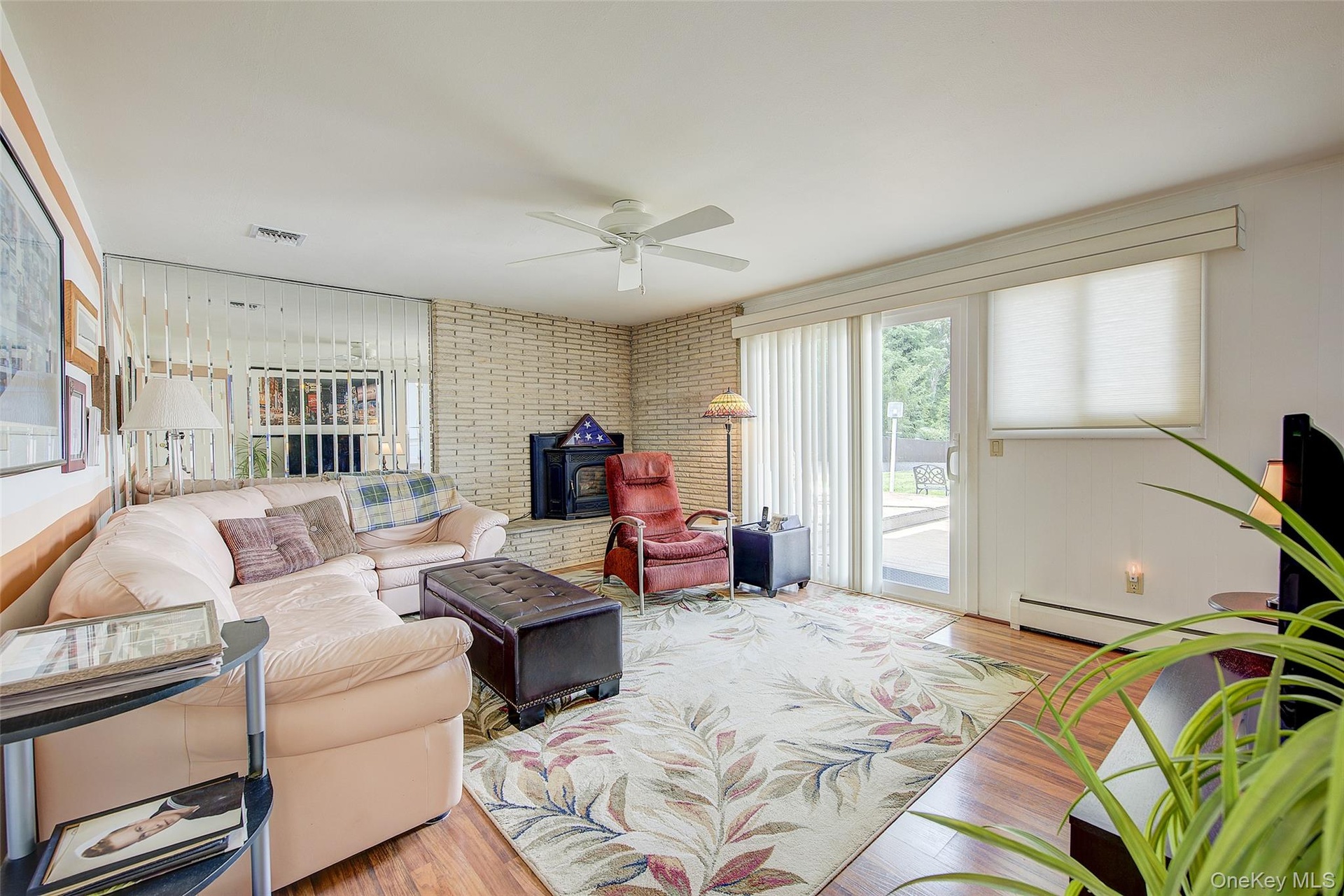 Den off the Entry Foyer with a fireplace and sliding glass doors to the rear deck.