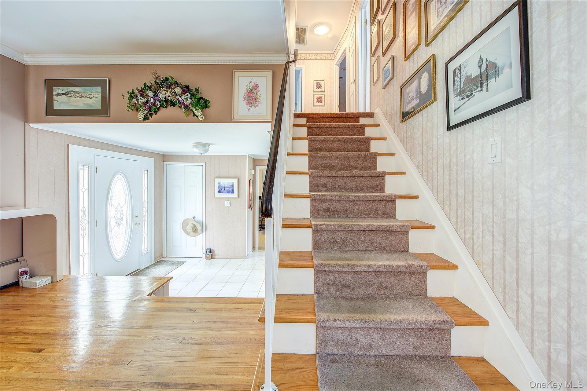Entry Foyer in the foreground and stairs to the 2nd floor .