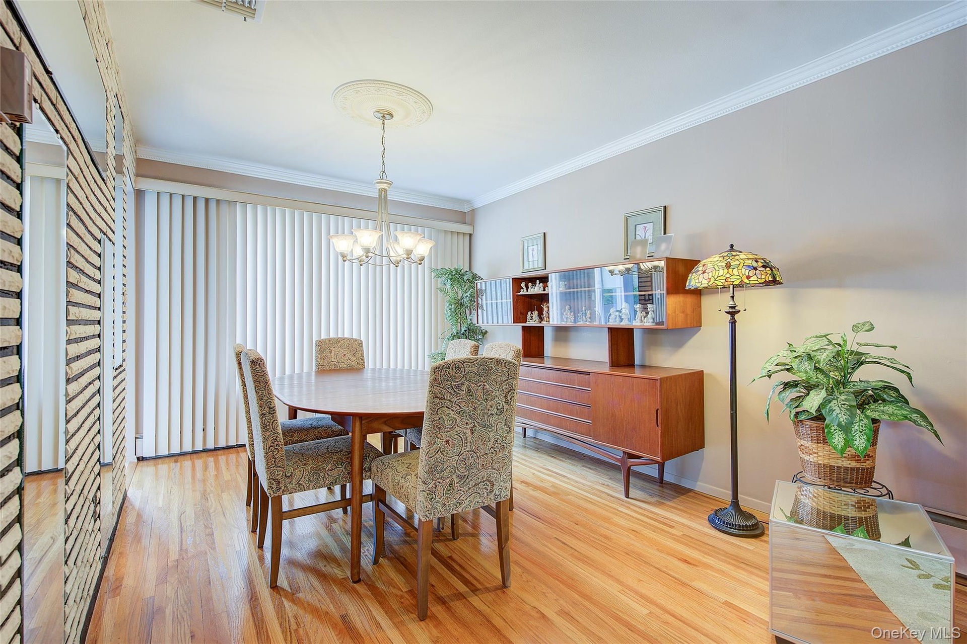 Dining area  Table, 6 Chairs, chandelier and a breakfront.