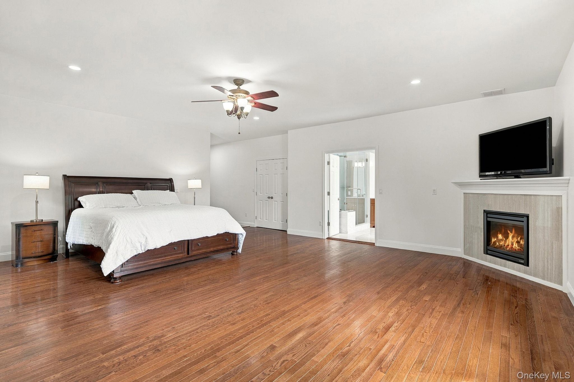 A distinguished primary retreat with generous proportions and a private corner fireplace.