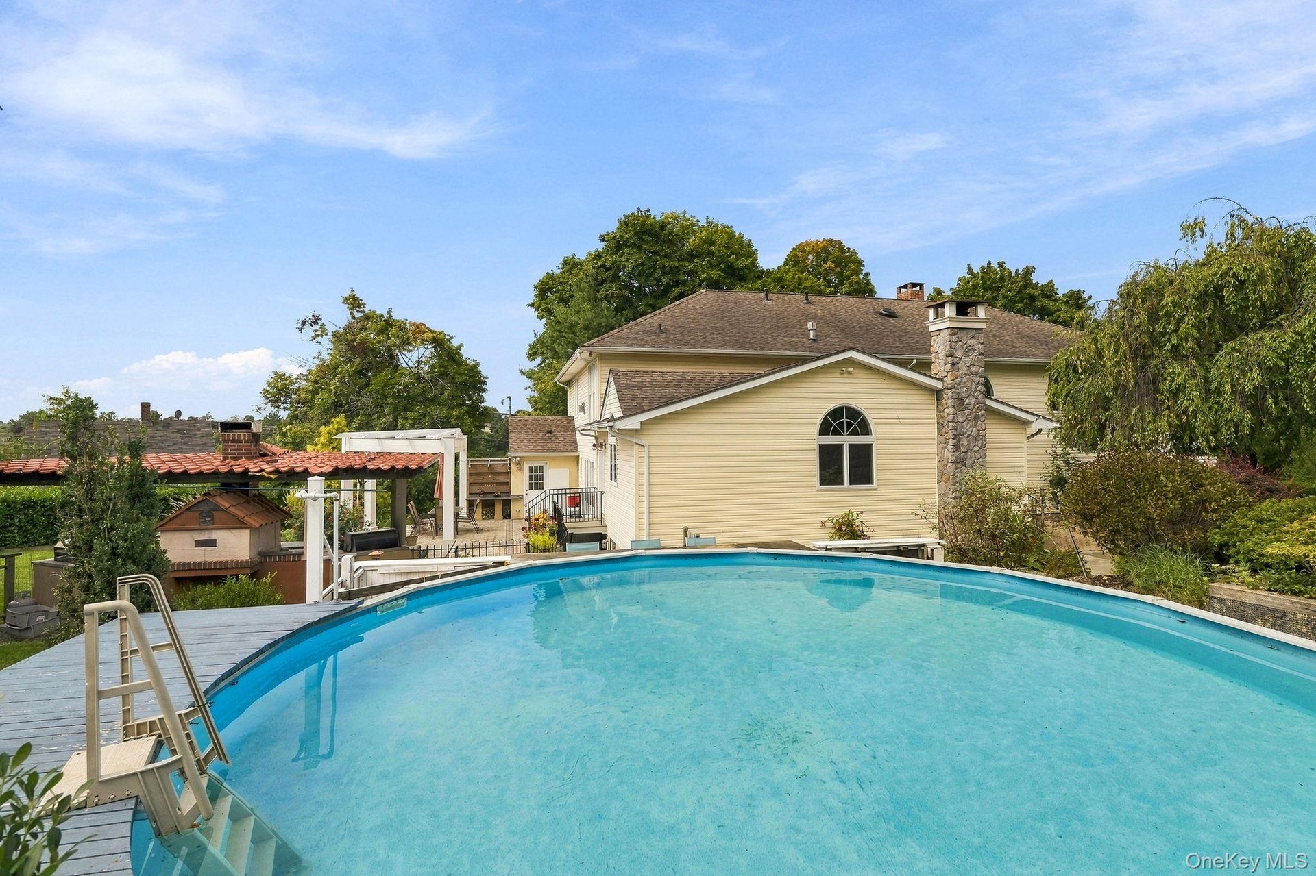 An above-ground pool and adjoining deck create a resort-like escape at home.