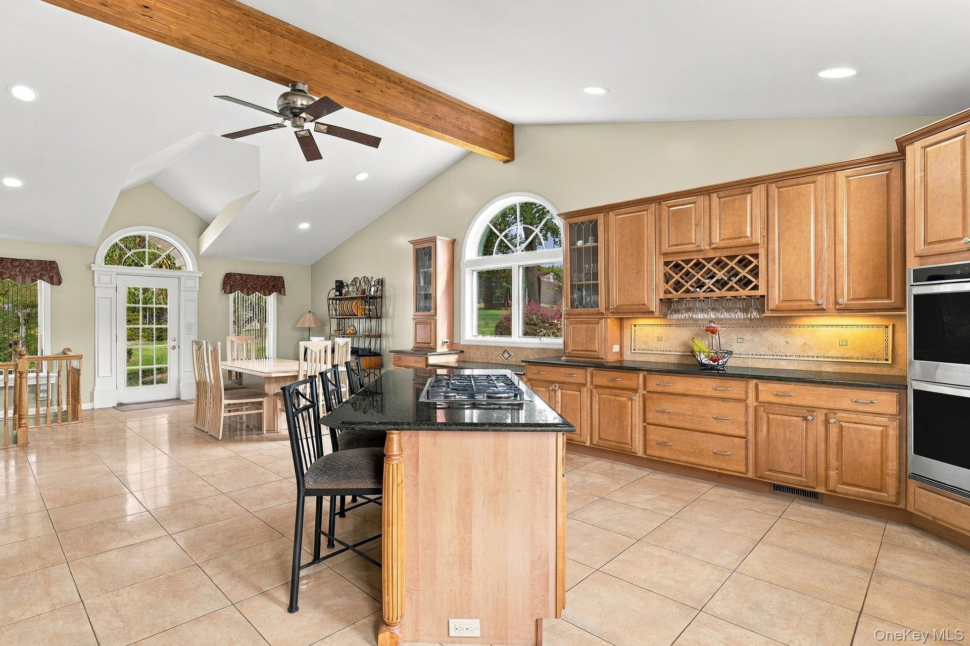 Expansive granite surfaces, custom cabinetry and a substantial center island create a kitchen of exceptional scale.