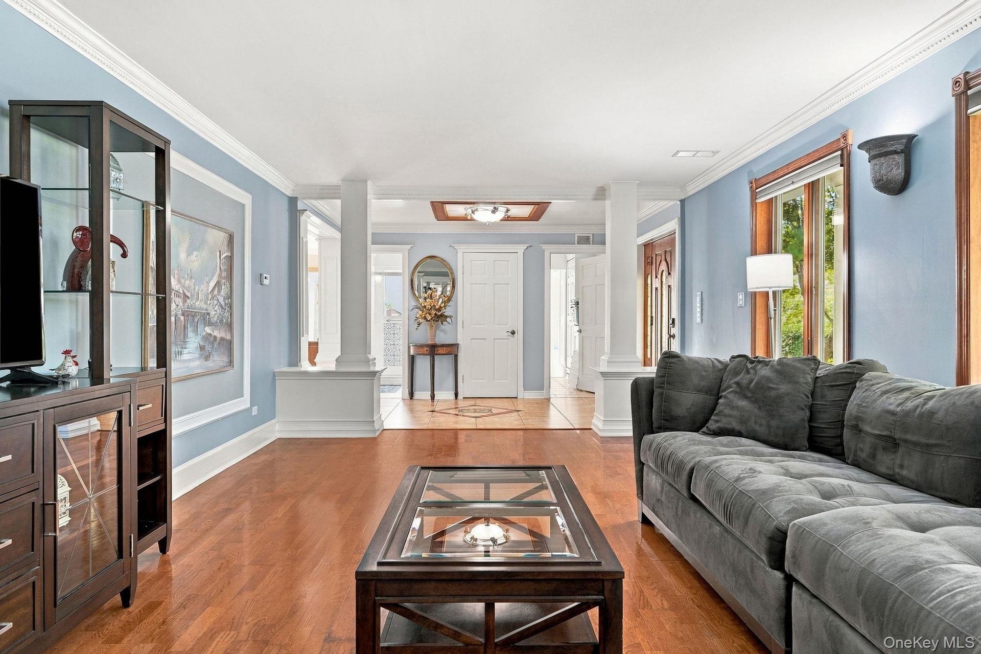 An impressive living room anchored by a handsome fireplace and abundant natural light.
