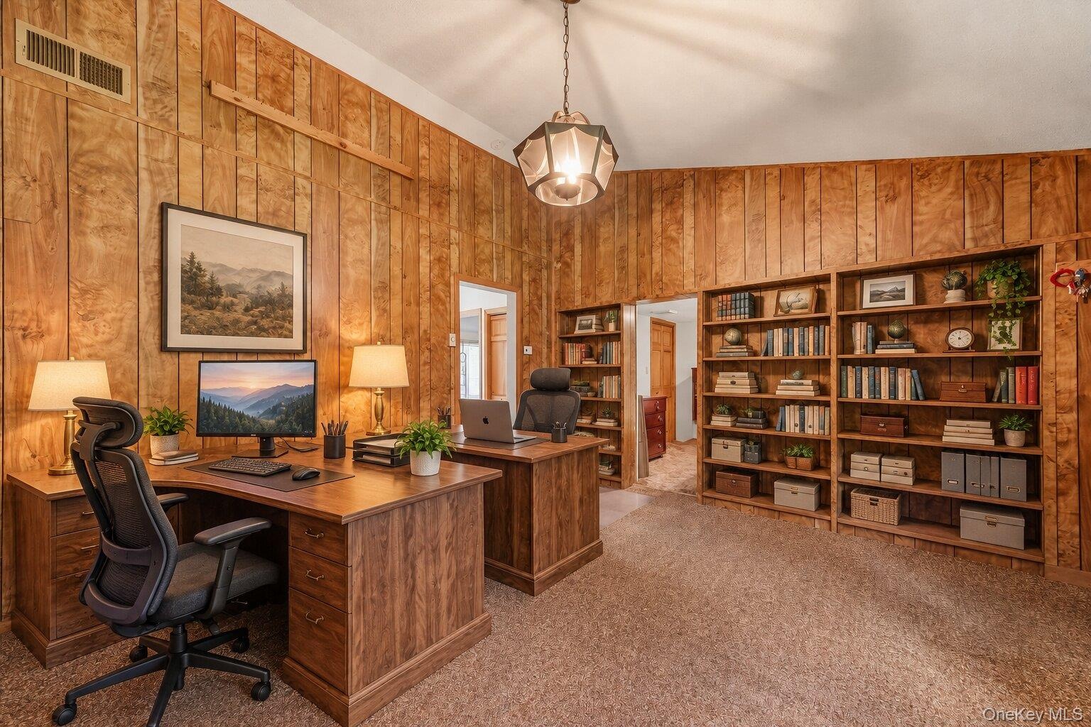Virtually staged home office showcasing the built-in shelving, generous workspace, and potential for multiple workstations.
