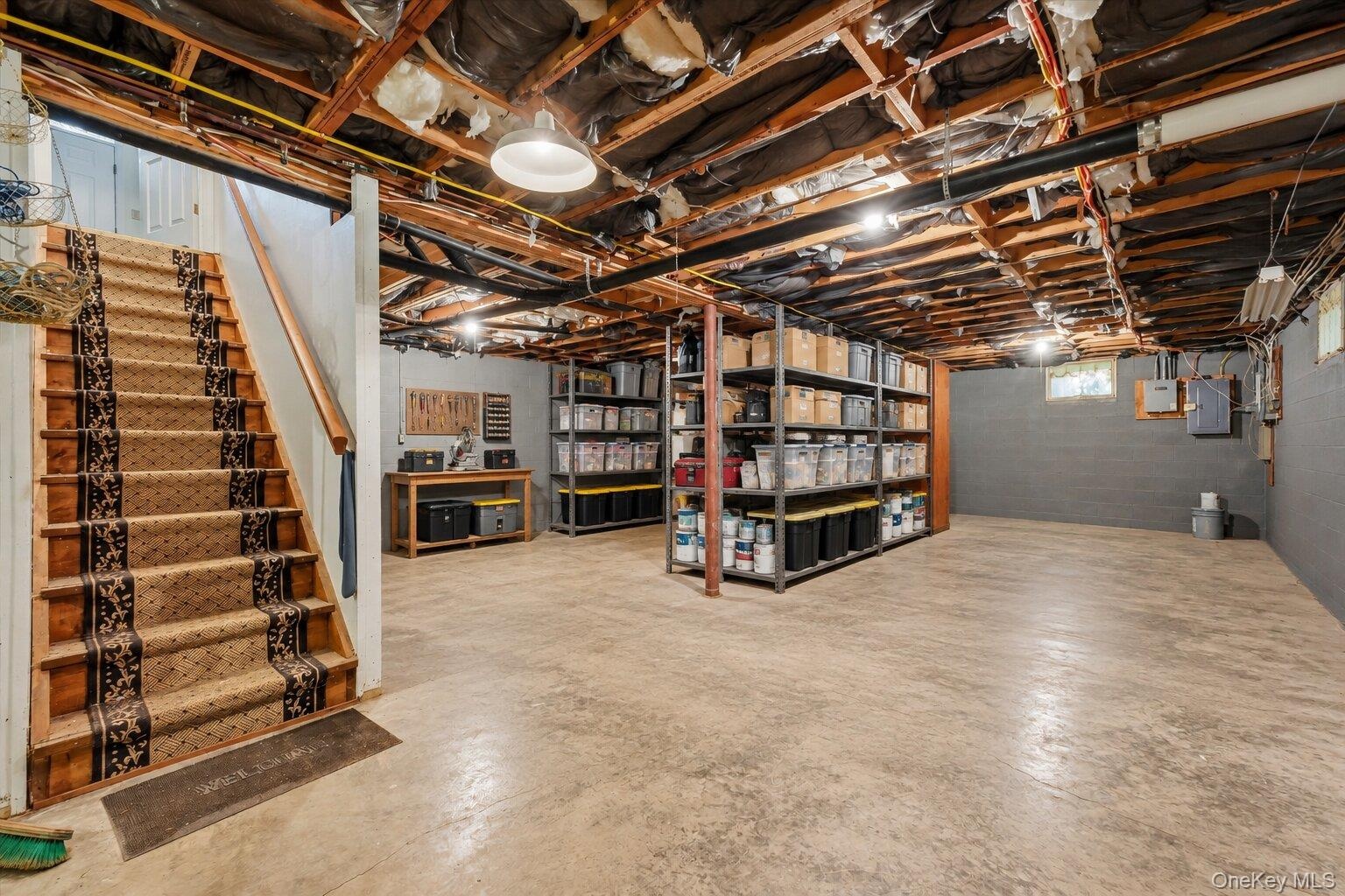 Virtually Staged. Basement showcasing the generous open space, storage areas, and workshop potential.