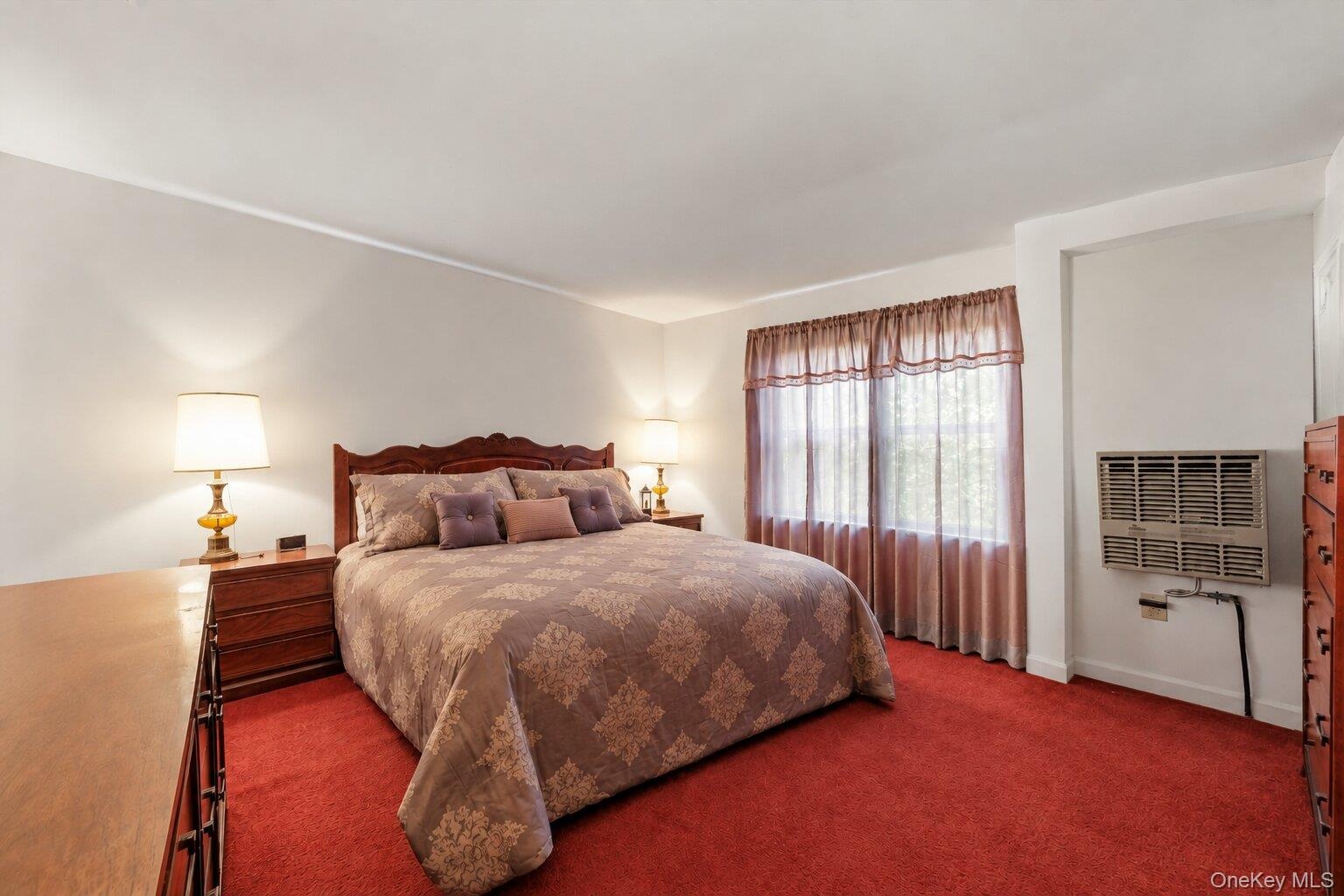 Well-sized bedroom with natural light and a flexible layout that accommodates a full bedroom suite.