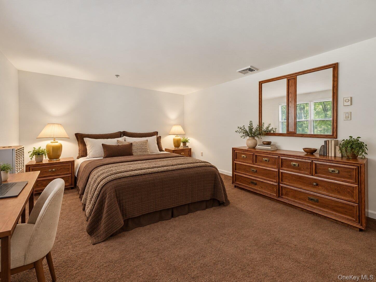 Virtually staged primary bedroom demonstrating the room’s generous dimensions and flexible furniture placement.
