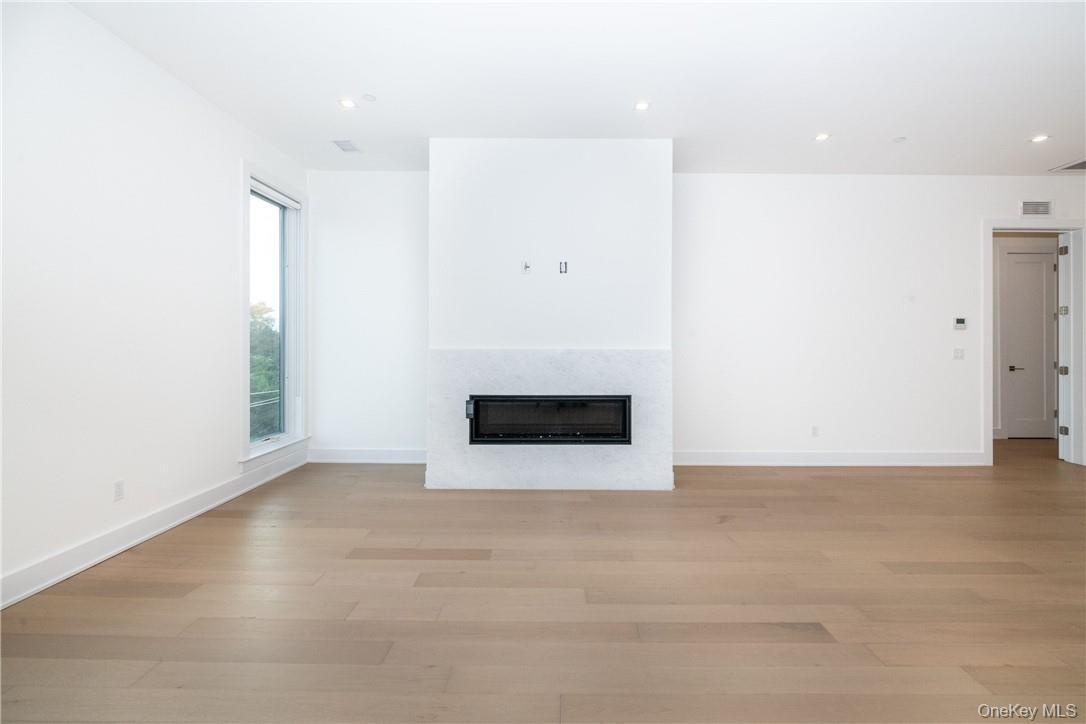 Unfurnished living room with light wood-type flooring