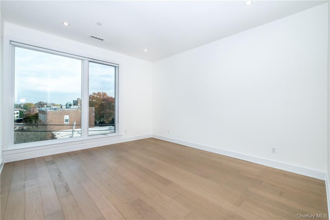 Empty room featuring hardwood / wood-style flooring