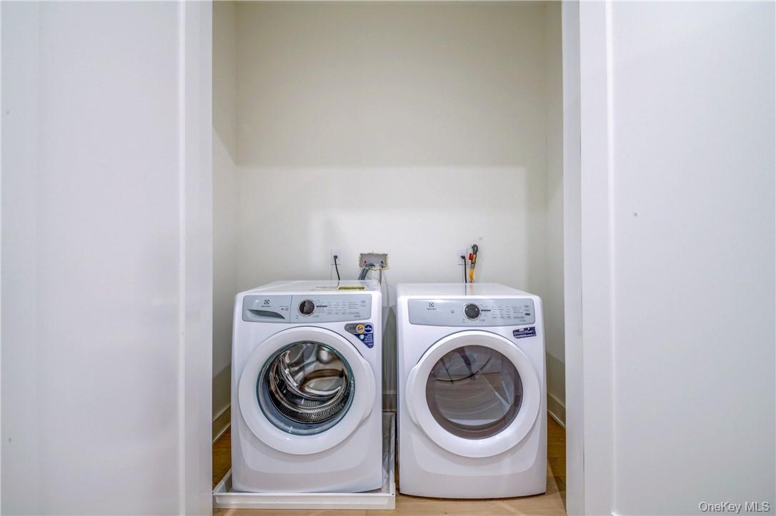 Laundry room featuring light hardwood / wood-style floors and independent washer and dryer