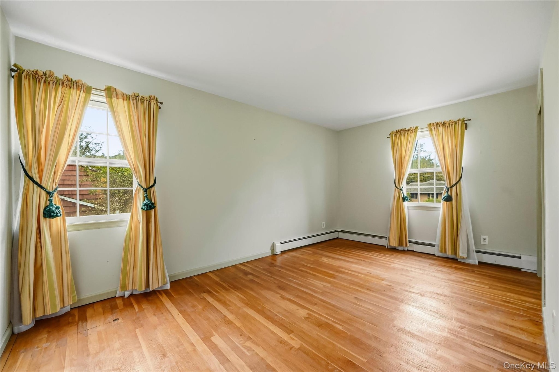 Bedroom #2 features hardwood floors and double windows