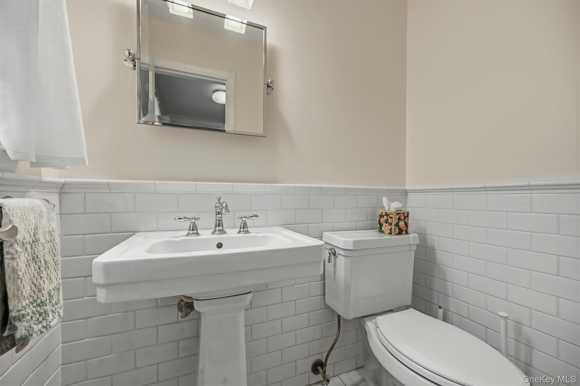 Updated clean and bright tiled powder room