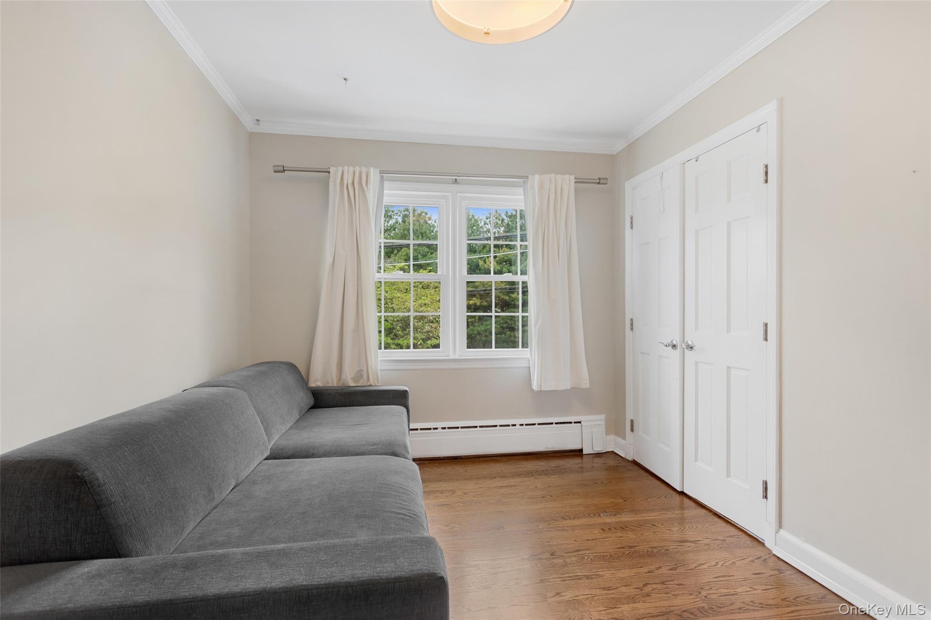 Third bedroom with double closet and window views.