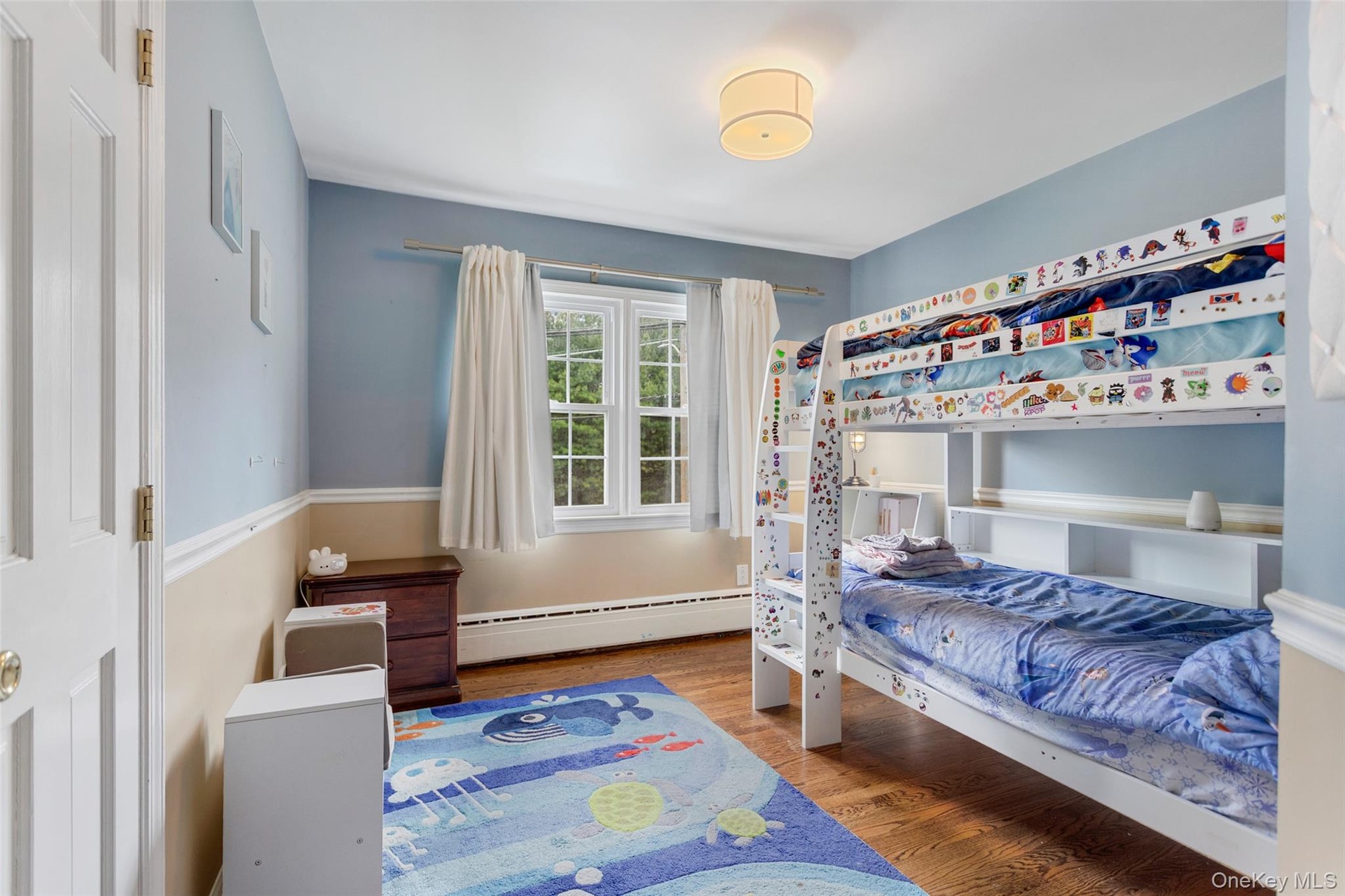 Second bedroom with double windows and neutral tones.