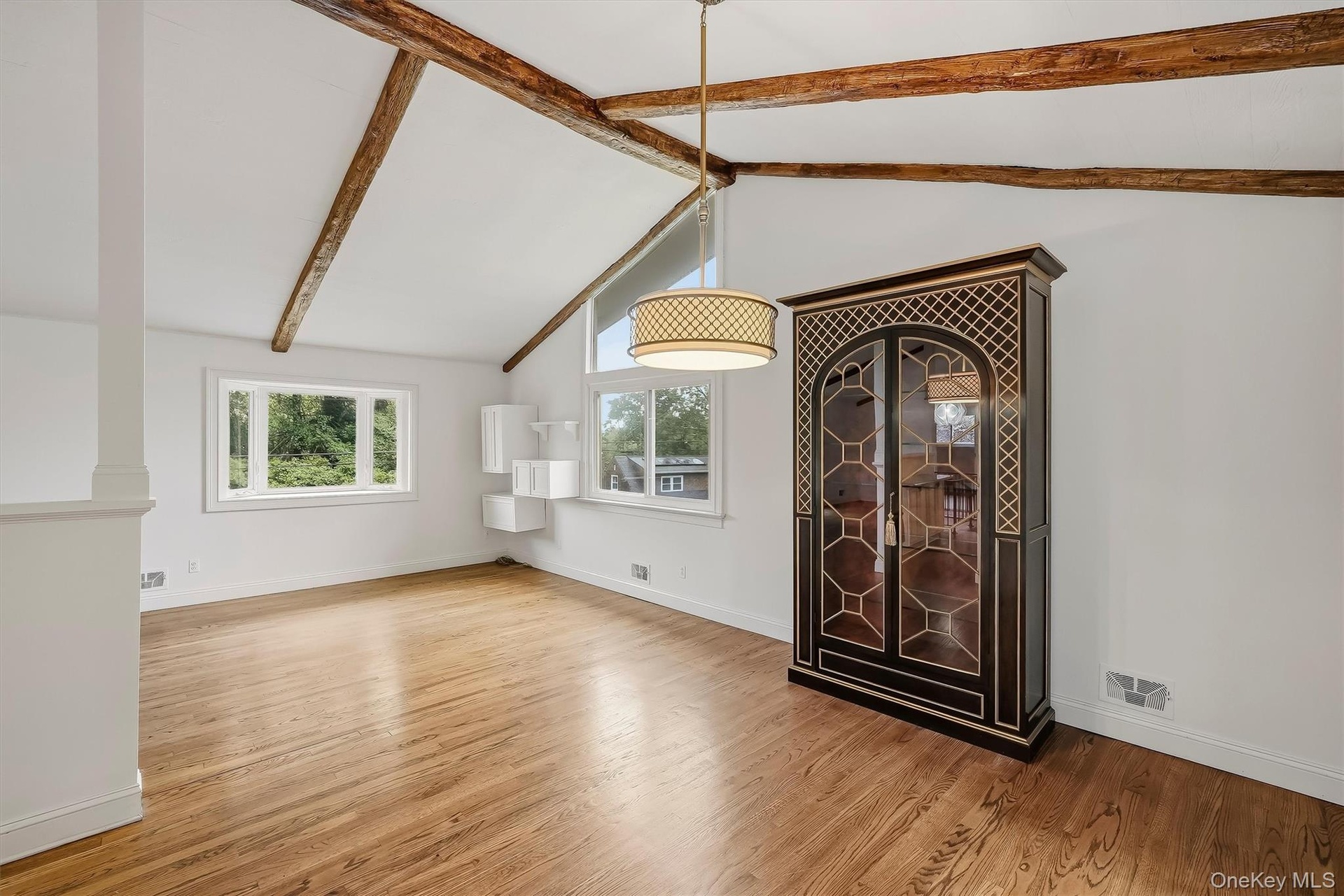 Dining area w/ hardwood floors and fresh paint.