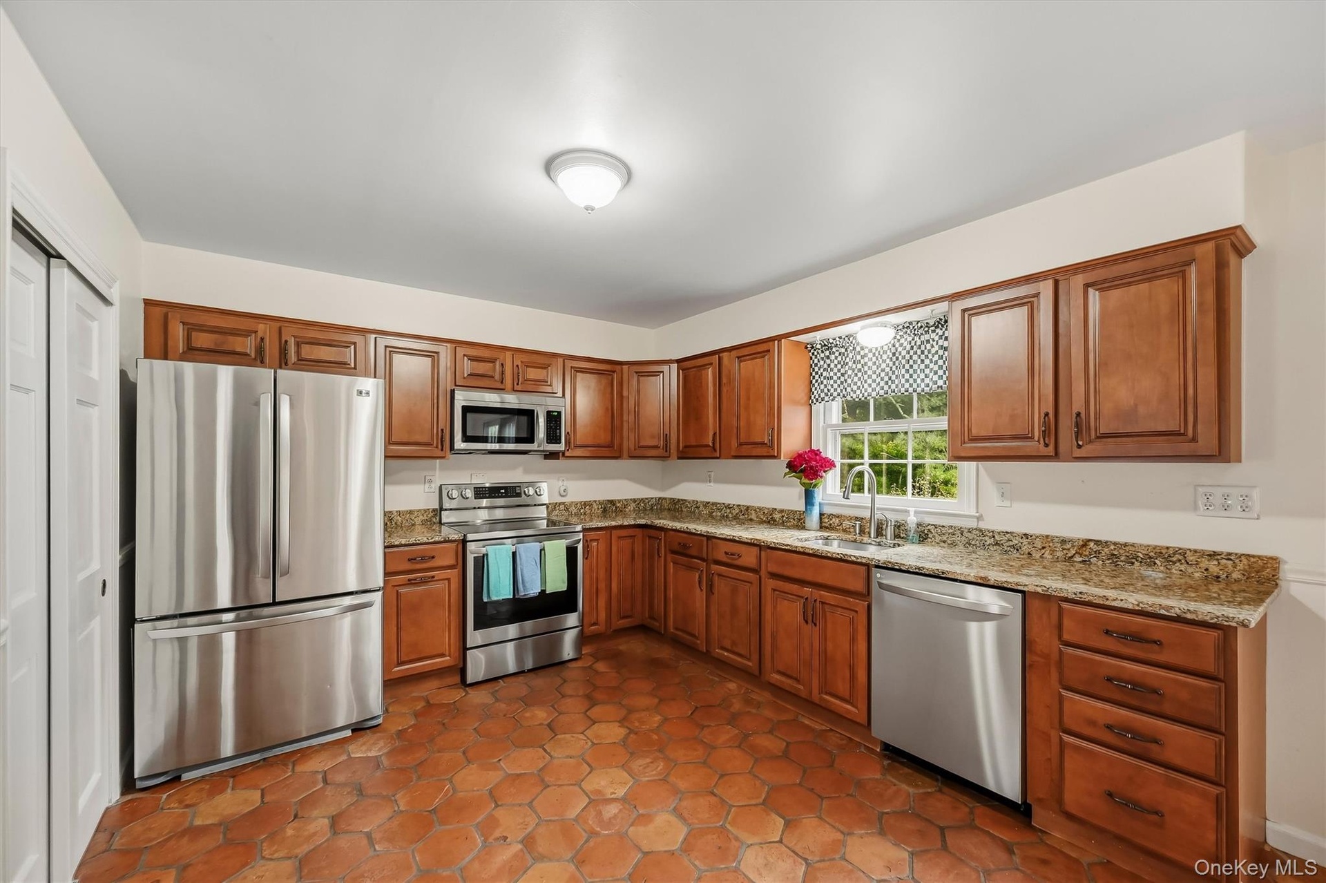 Plenty of wood cabinetry, stainless steel appliances and granite counter tops make meal prep a breeze.