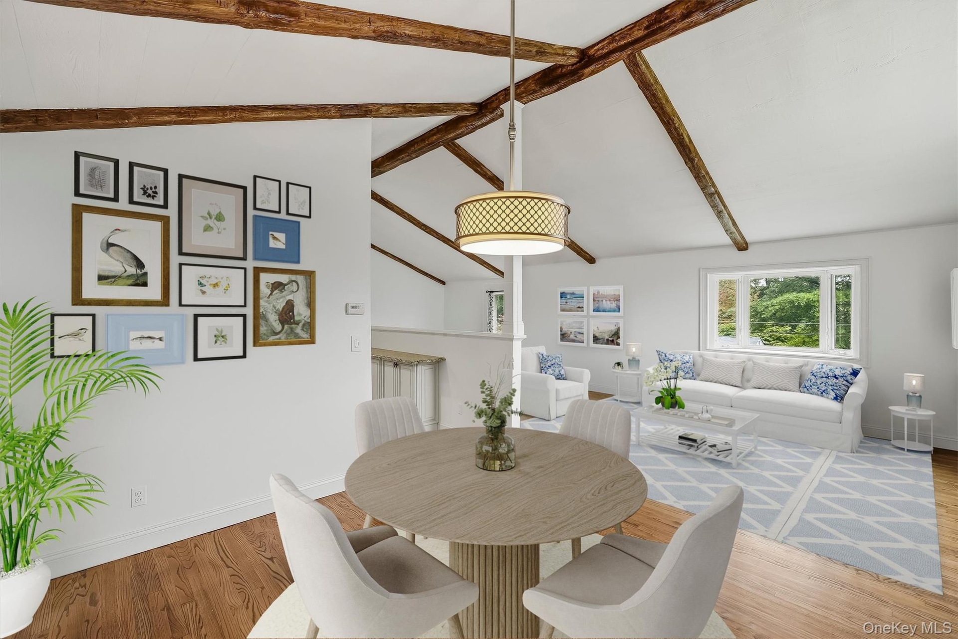 Virtually staged dining area w/ hardwood floors and fresh paint.