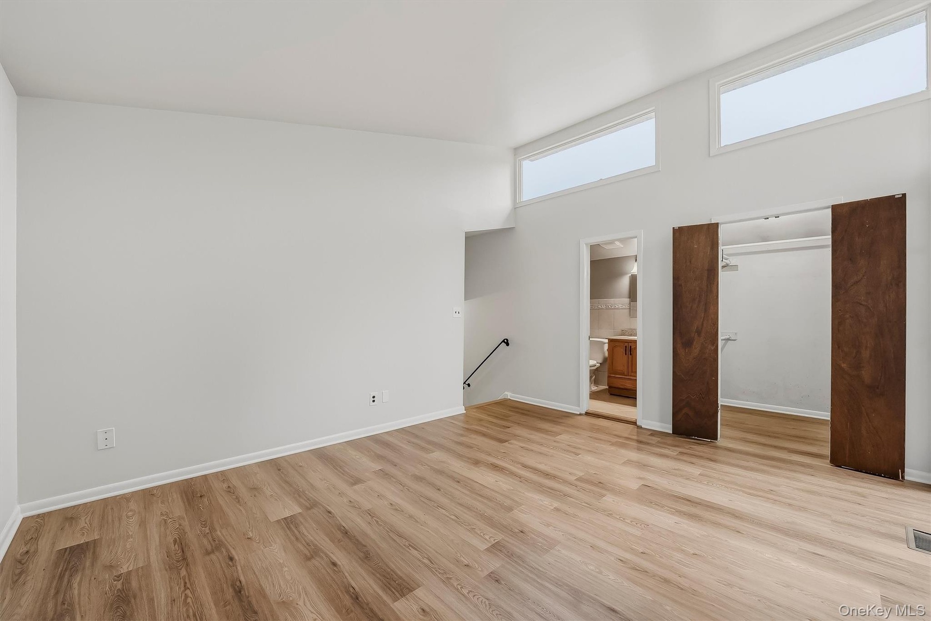 Primary bedroom with brand new floors, en-suite bathroom, & walk-in closet.