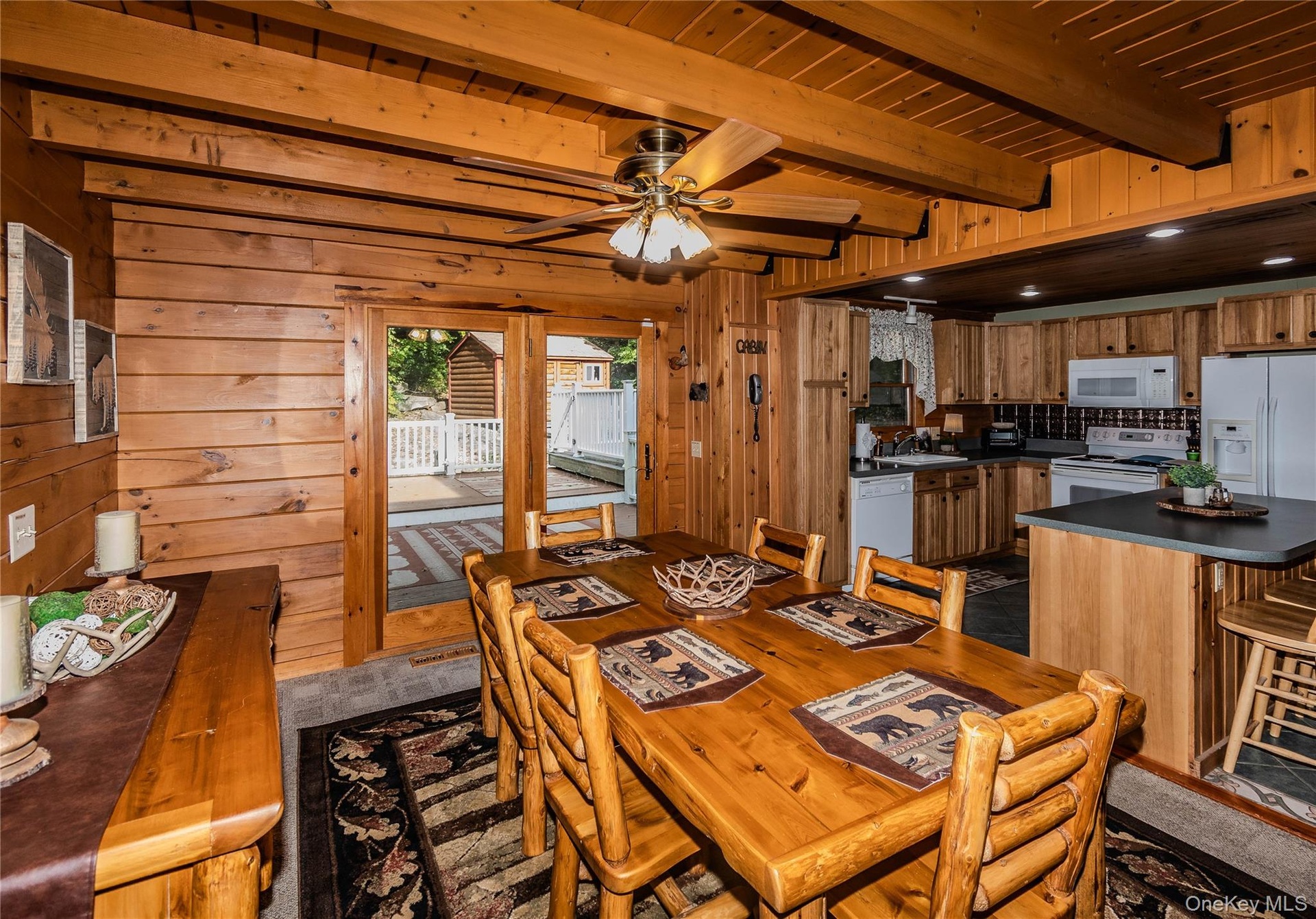 Wood-paneled interior featuring exposed ceiling beams and recessed lighting