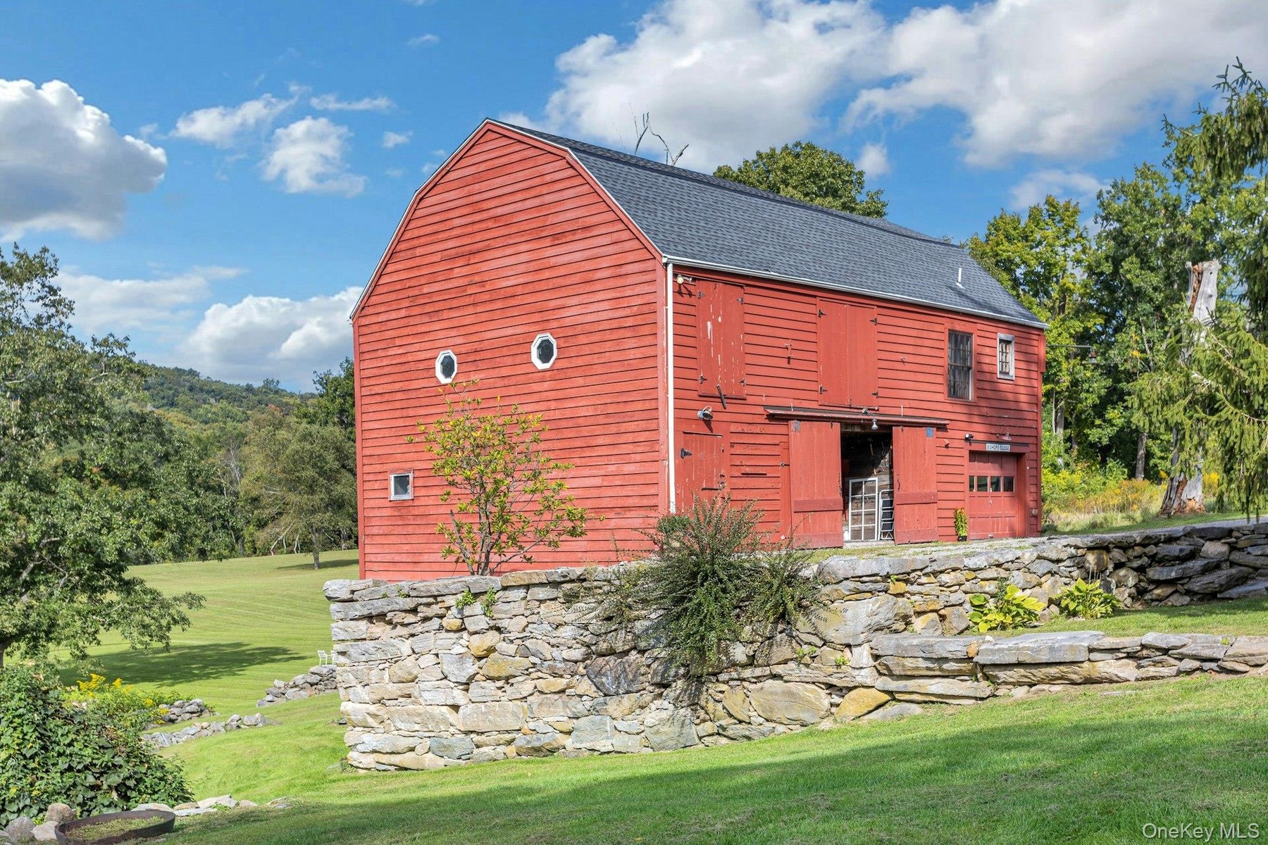 Totally renovated  original  barn with party room,  full kitchen, full bath, two bedroom apartment and 3 car garage.