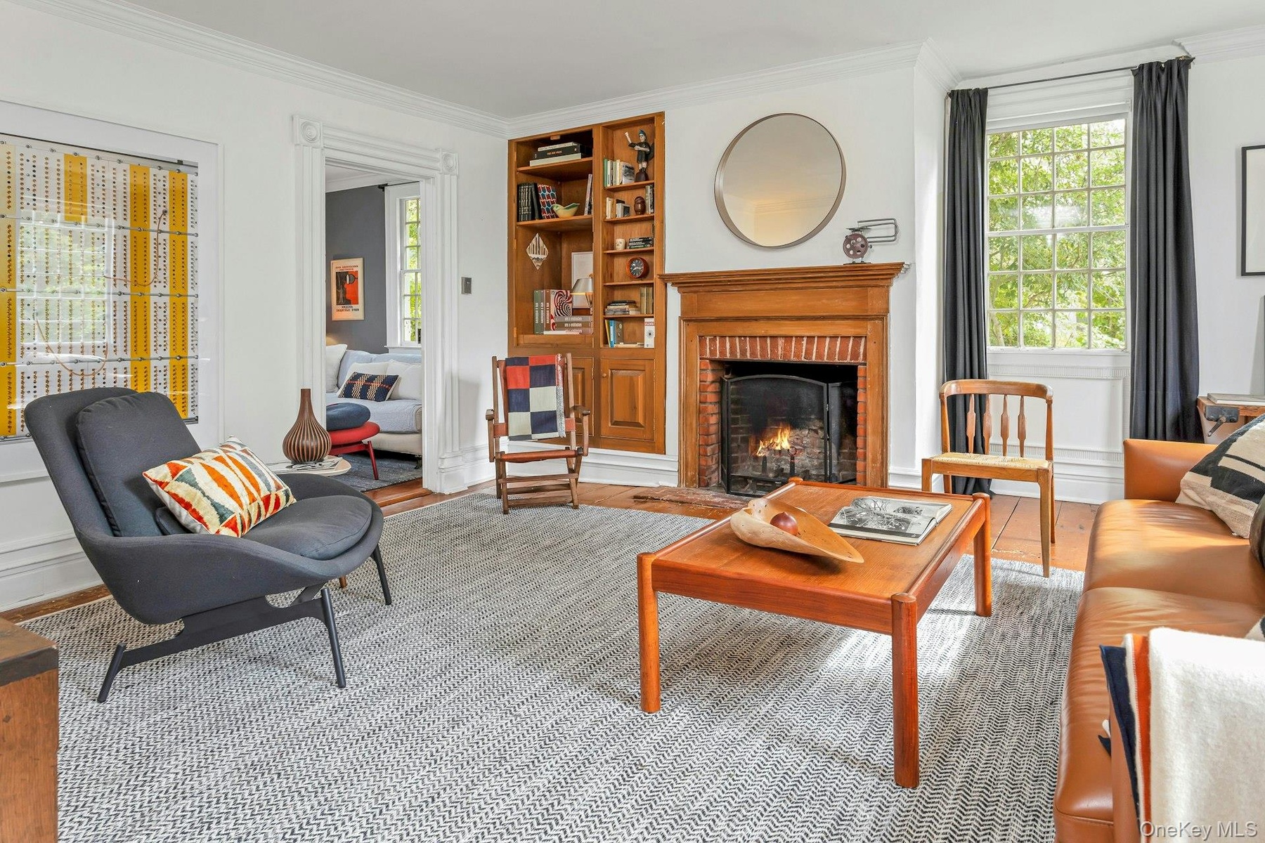 Another beautiful  fireplace, high ceilings and over-sized windows