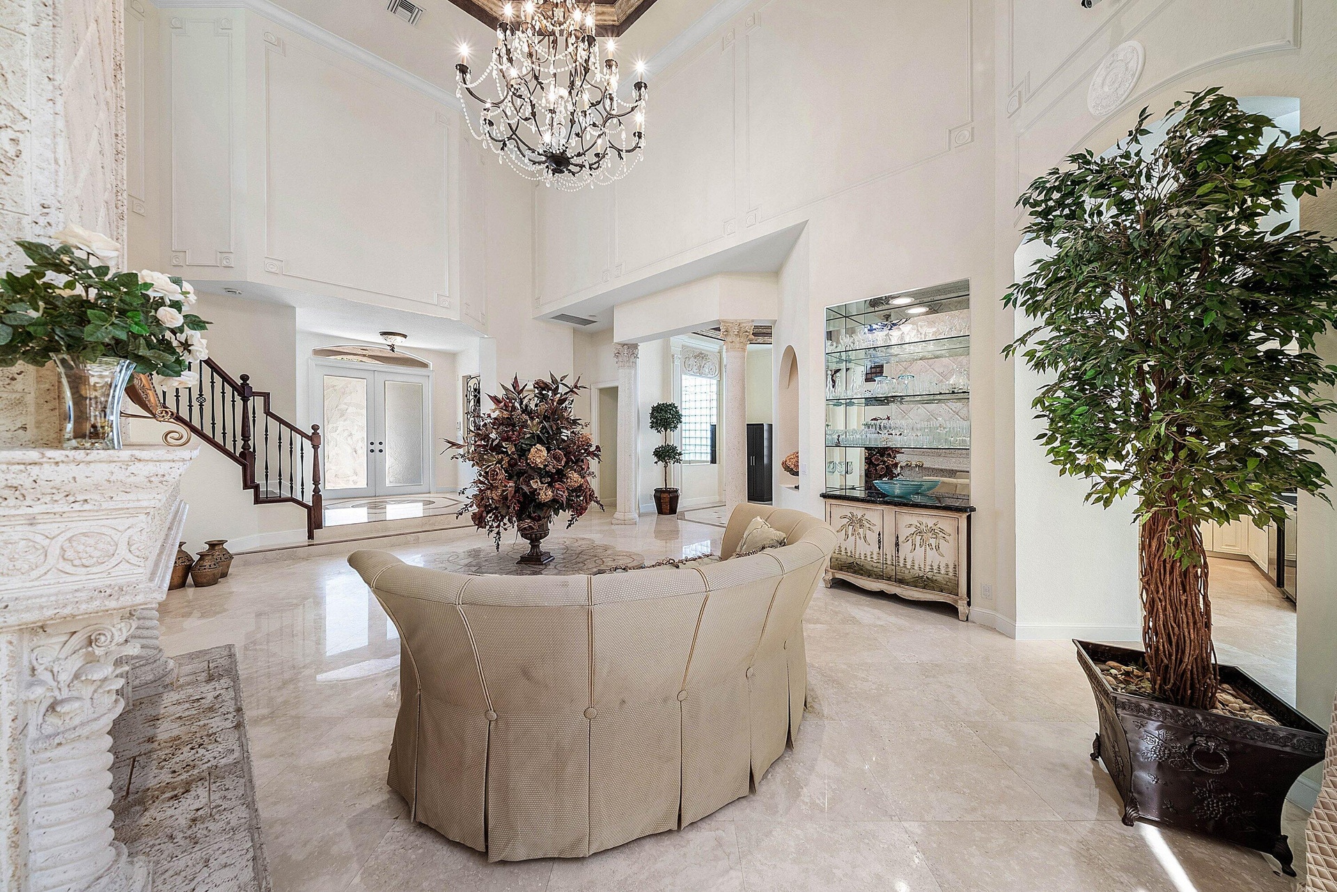 Soaring ceilings with decorative molding, marble flooring.