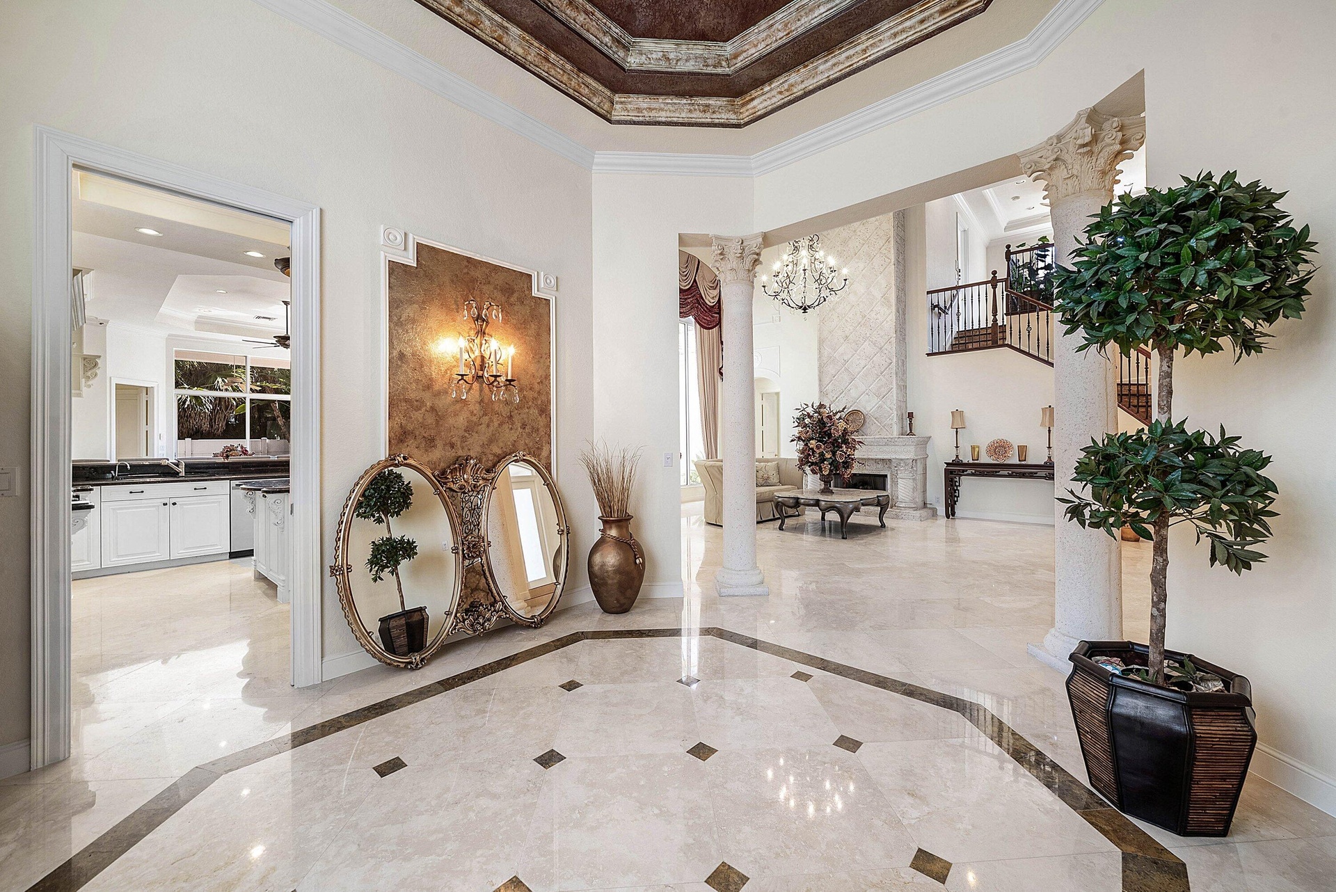 Formal dining area with marble flooring with inlay detail, decorative ceiling with intricate molding with faux painting