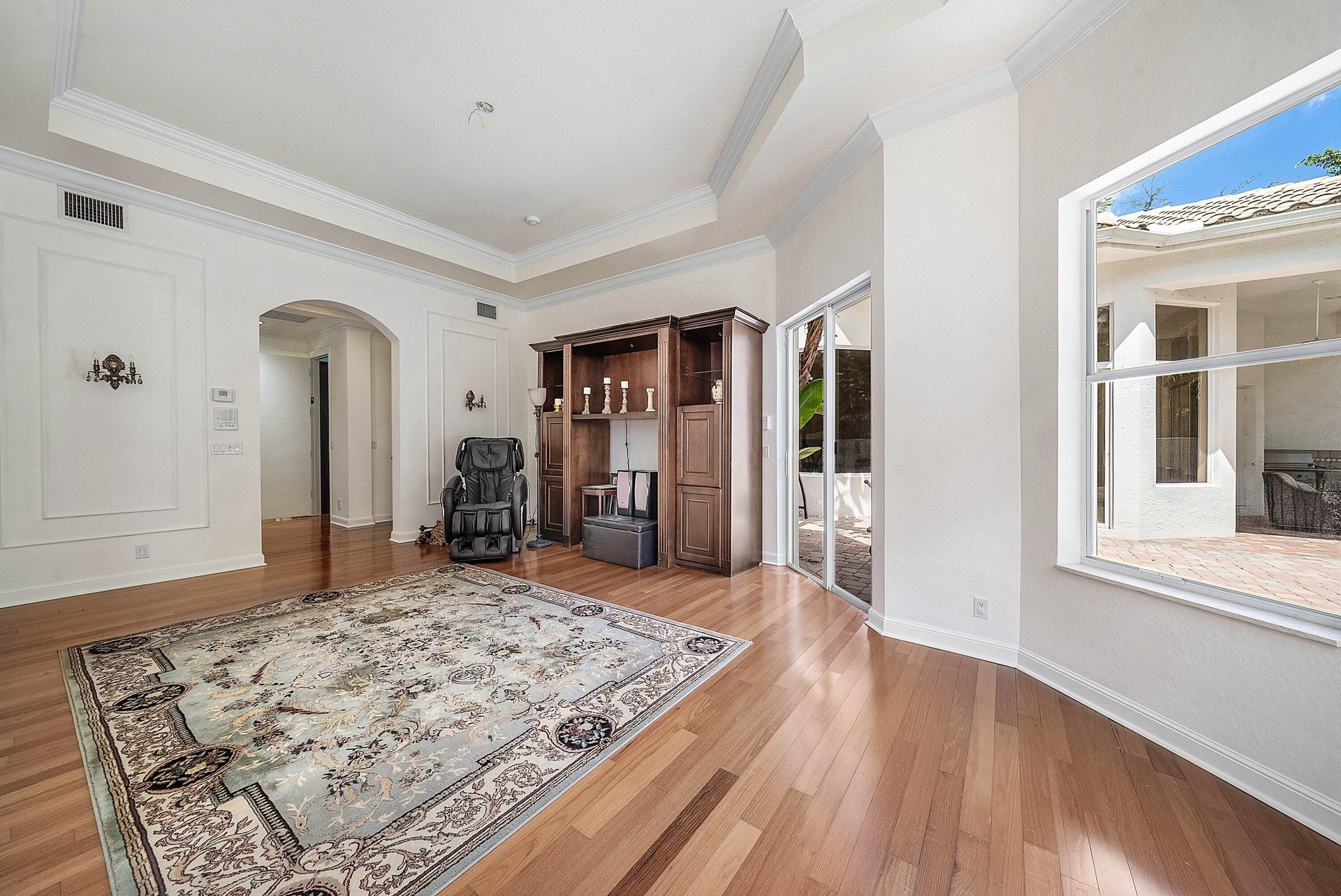 Engineered Hardwood flooring, crown molding, tray ceiling - slider access out to pool area
