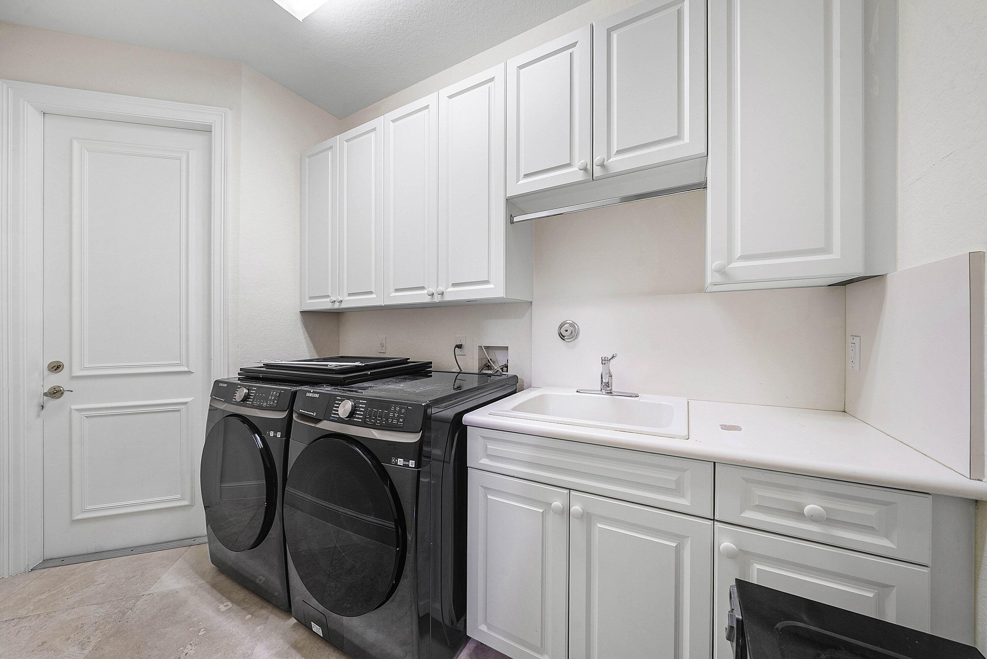Laundry Room with ample storage, access to 2 car main garage