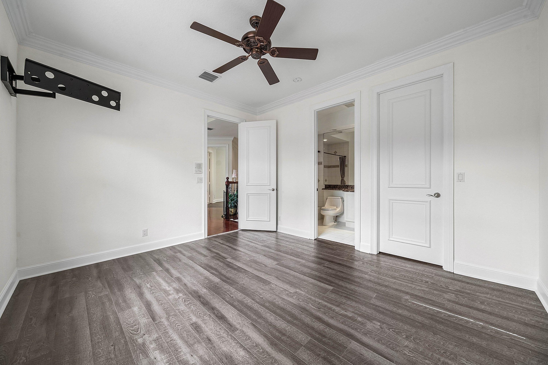 En-Suite bedroom #3 with wood-finish flooring throughout, crown molding, and a ceiling fan