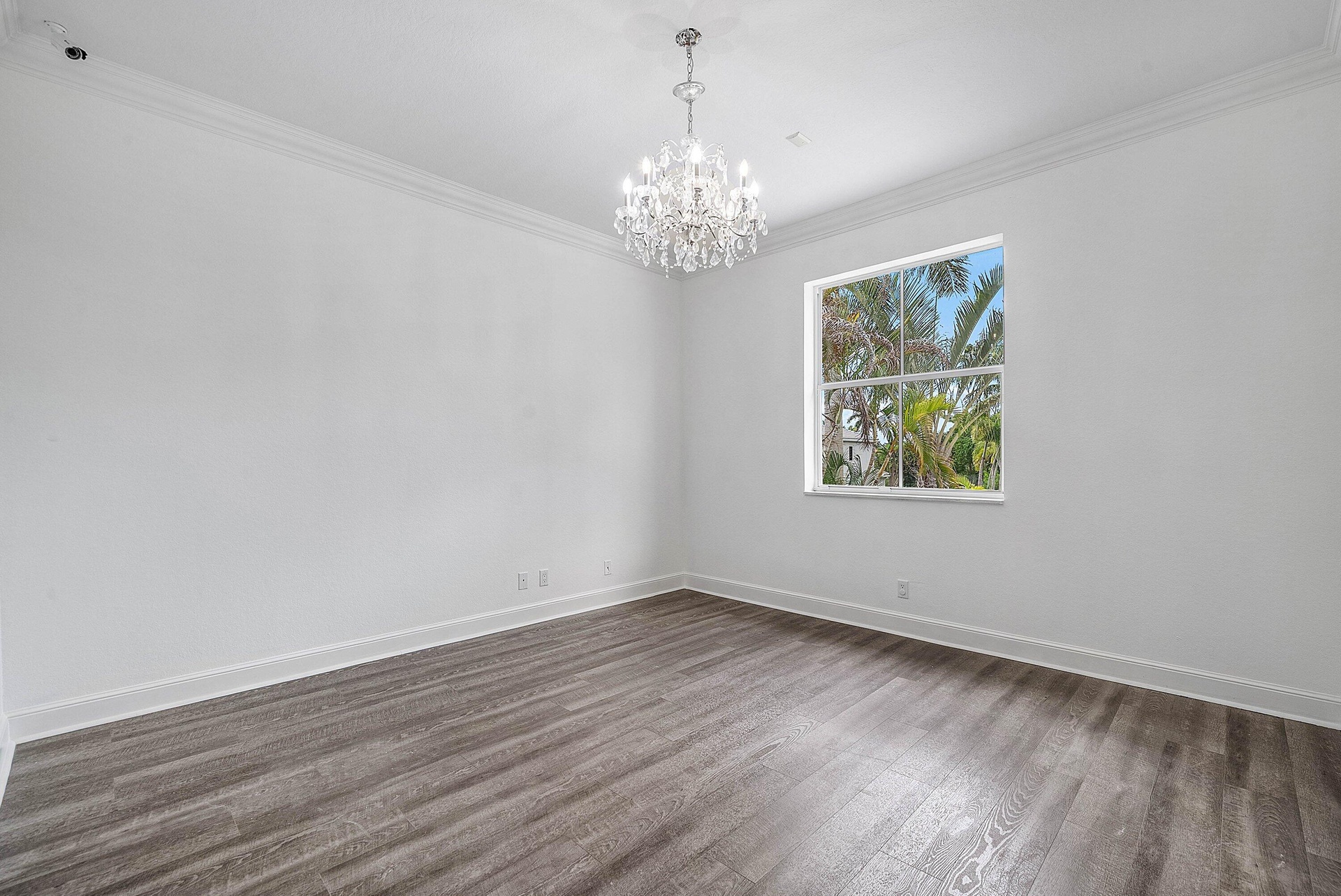 Crown molding, wood-finish flooring, and a chandelier