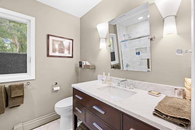 Second full bath. Single vanity with a white countertop and integrated sink, dark wood-finish cabinetry, and chrome fixtures.