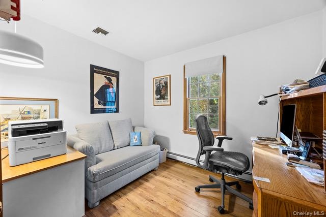 Bedroom or versatile home office featuring hardwood flooring, recessed ceiling lighting, and ample natural light