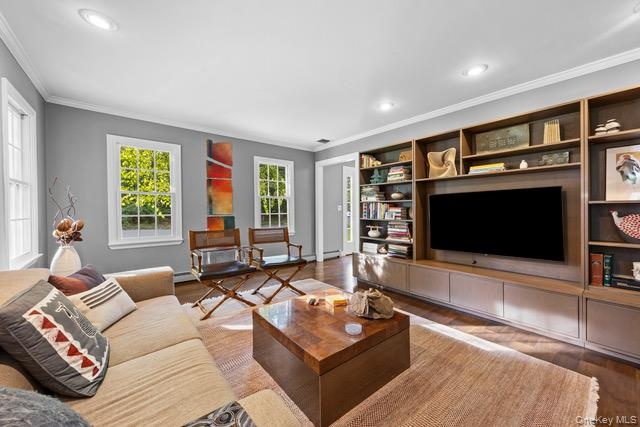 Recessed lighting, crown molding, wood-finish flooring, and multiple windows