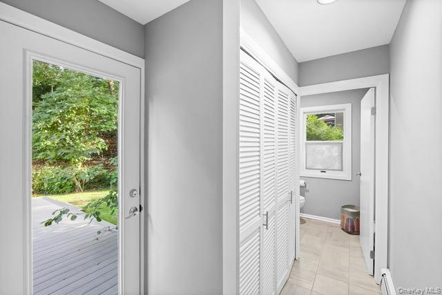 From kitchen. Laundry behind white louvered bifold doors, recessed ceiling lighting, and light gray wall paint