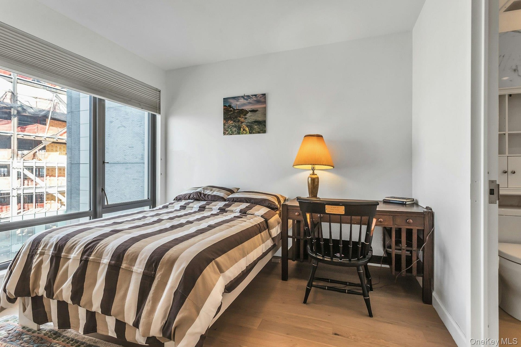 Bedroom featuring light wood-type flooring and baseboards