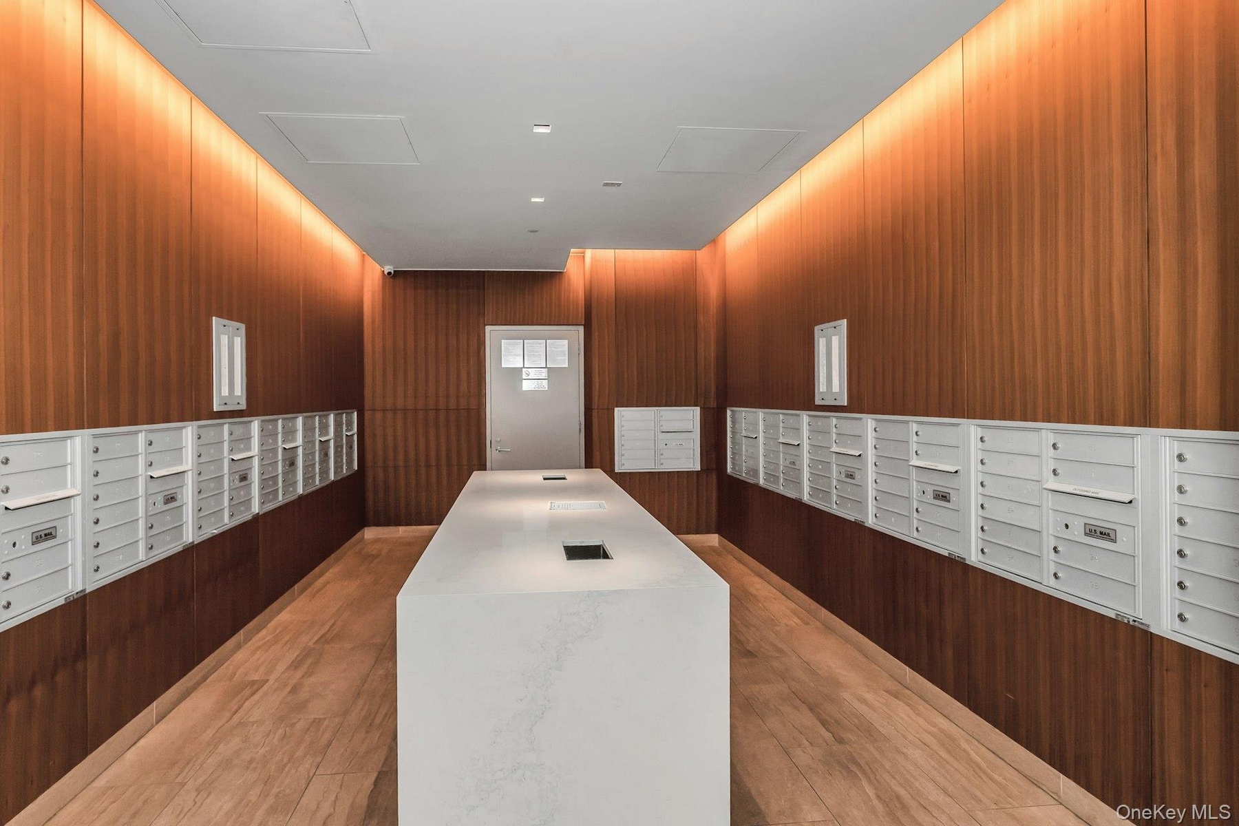Surrounding community featuring wood walls and mail area