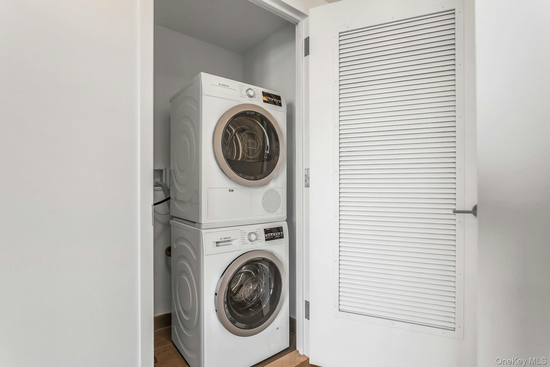 Washroom featuring estacked washer and dryer