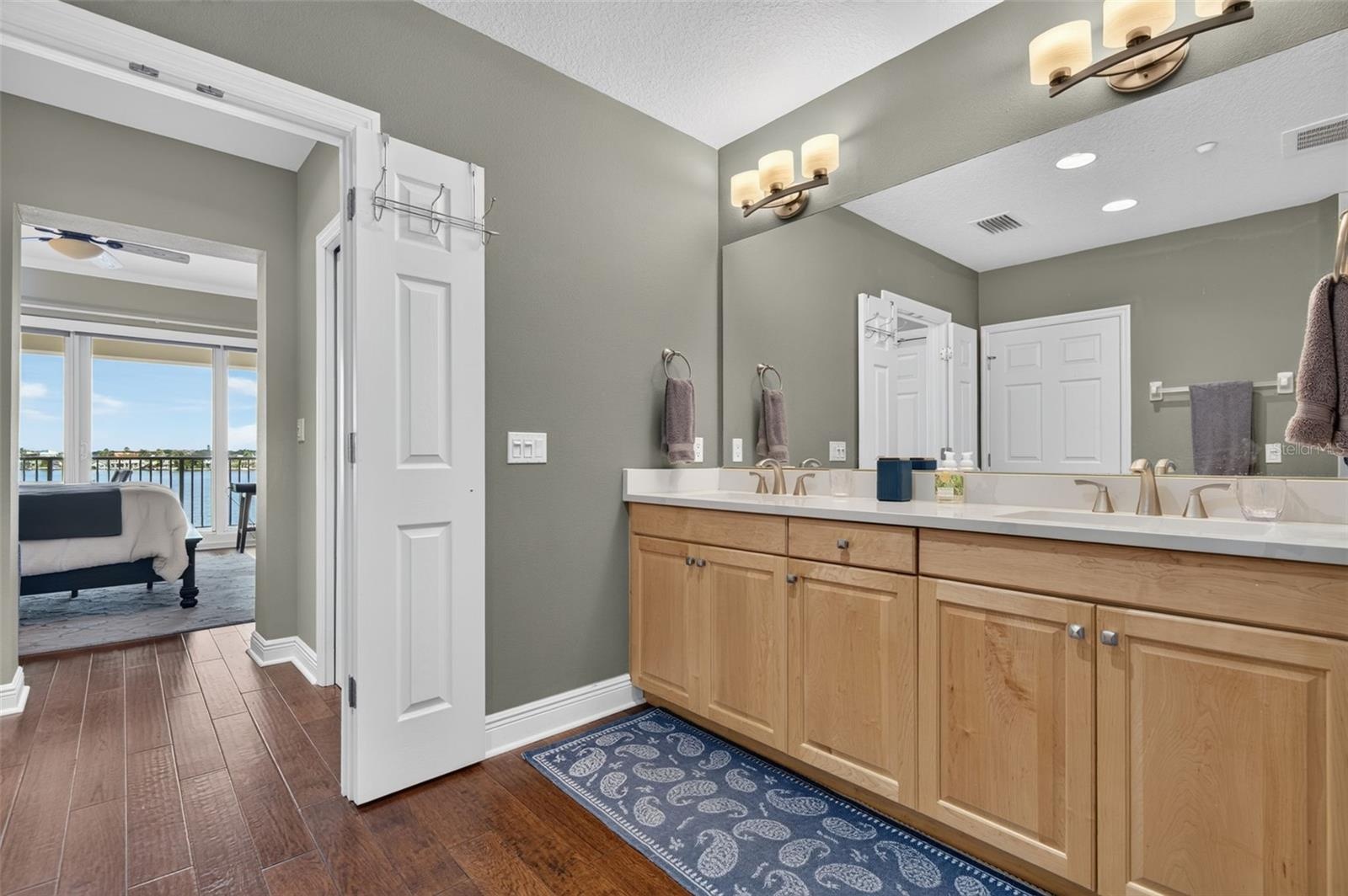 Dual walk-in closets in hall between bath & bed