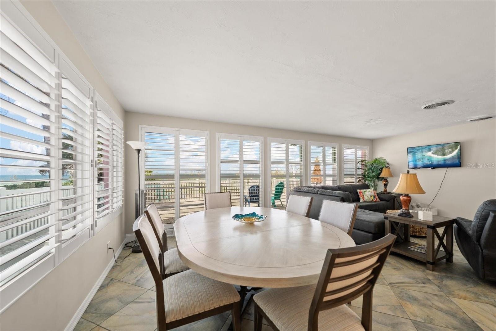 Main home-dining area with open flow to living room-all enjoy the beach views!