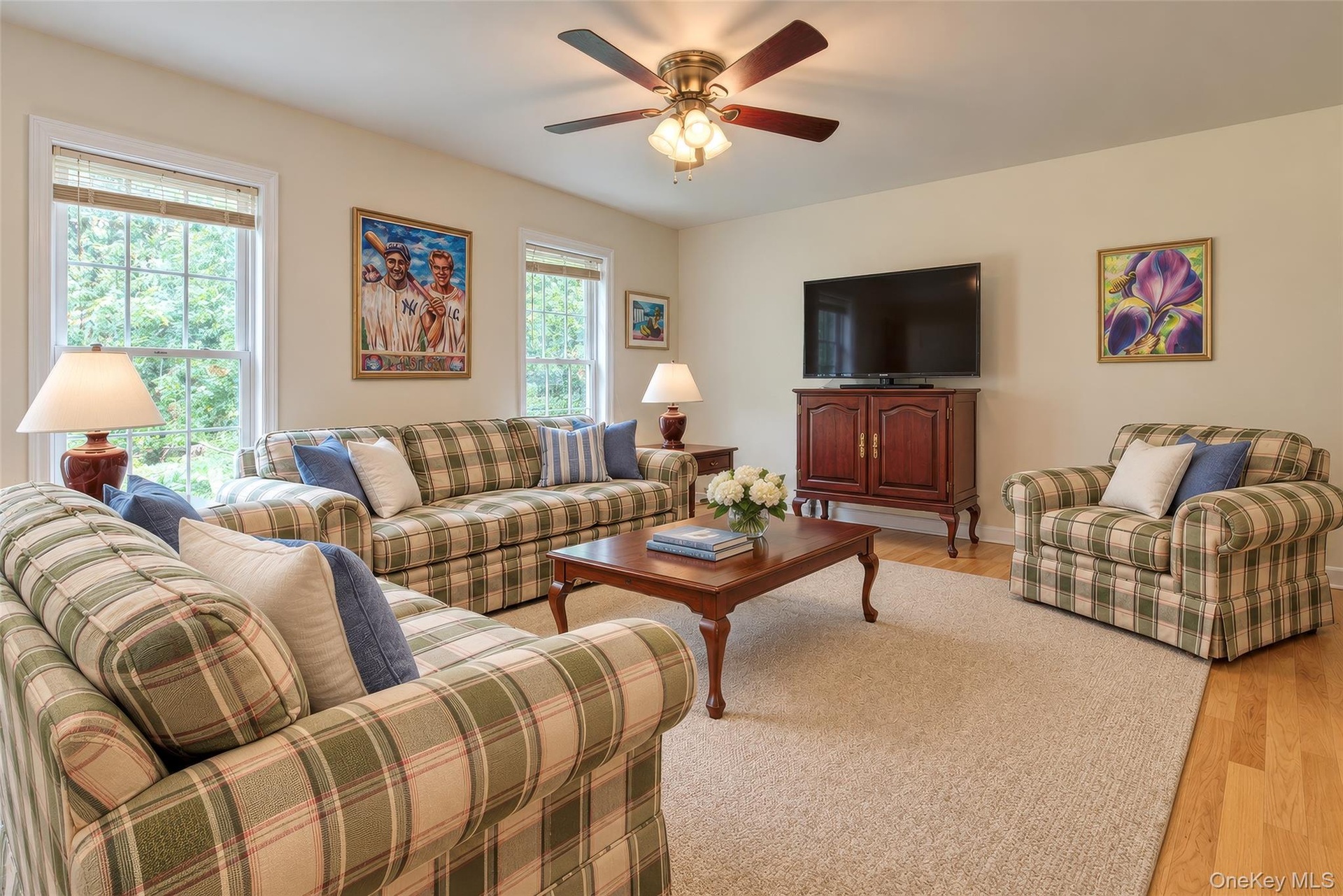 Recessed lighting, wood-finish flooring, and a ceiling fan with integrated lighting