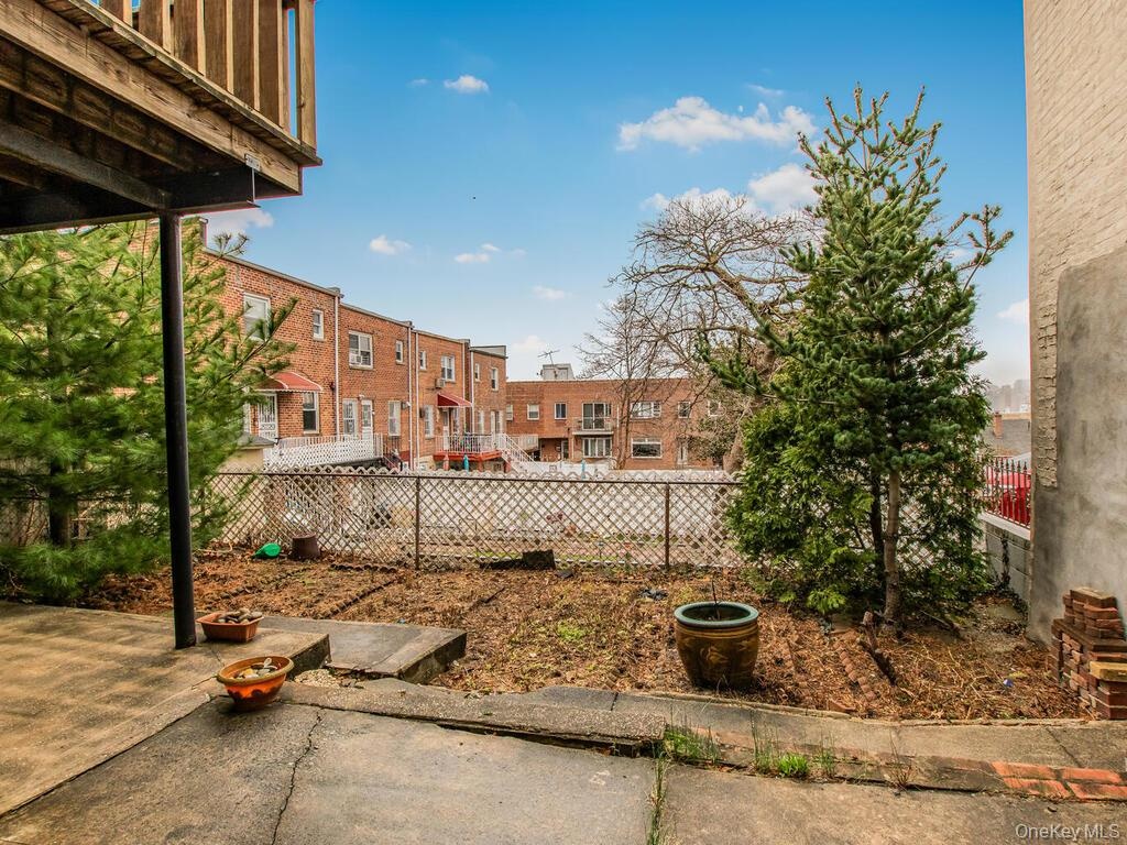 View of yard featuring fence and a residential view