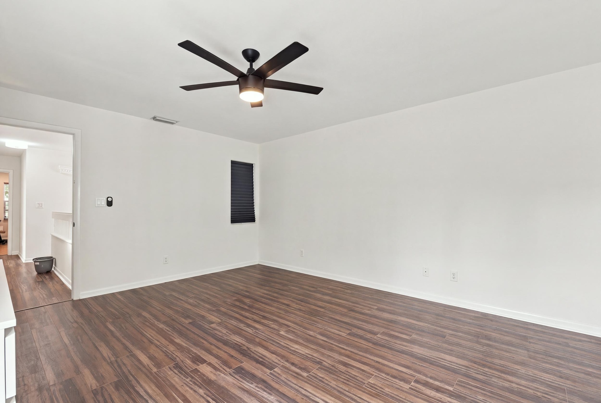 The elegant primary suite offers a private retreat with a beautifully updated bathroom, spacious walk-in closets, and a private balcony overlooking th