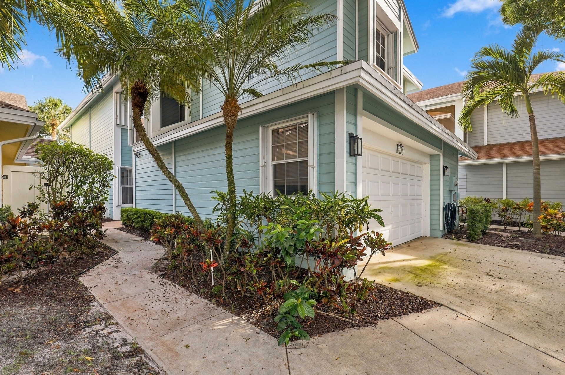 Before you step inside, you are welcomed by the charm of Fairfield, a gated community in Central Boca Raton featuring mature oak trees and an impressi