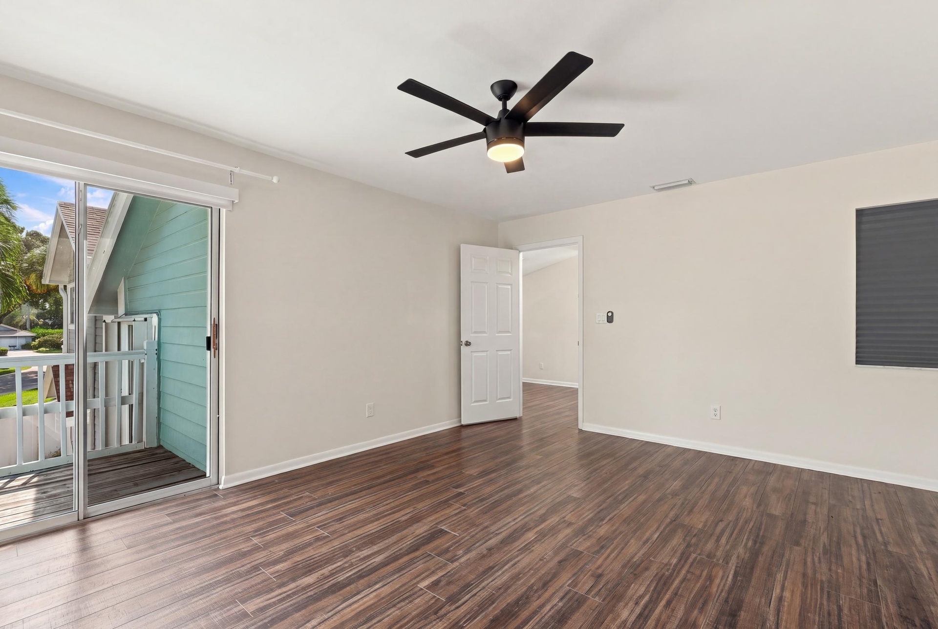 The elegant primary suite offers a private retreat with a beautifully updated bathroom, spacious walk-in closets, and a private balcony overlooking th