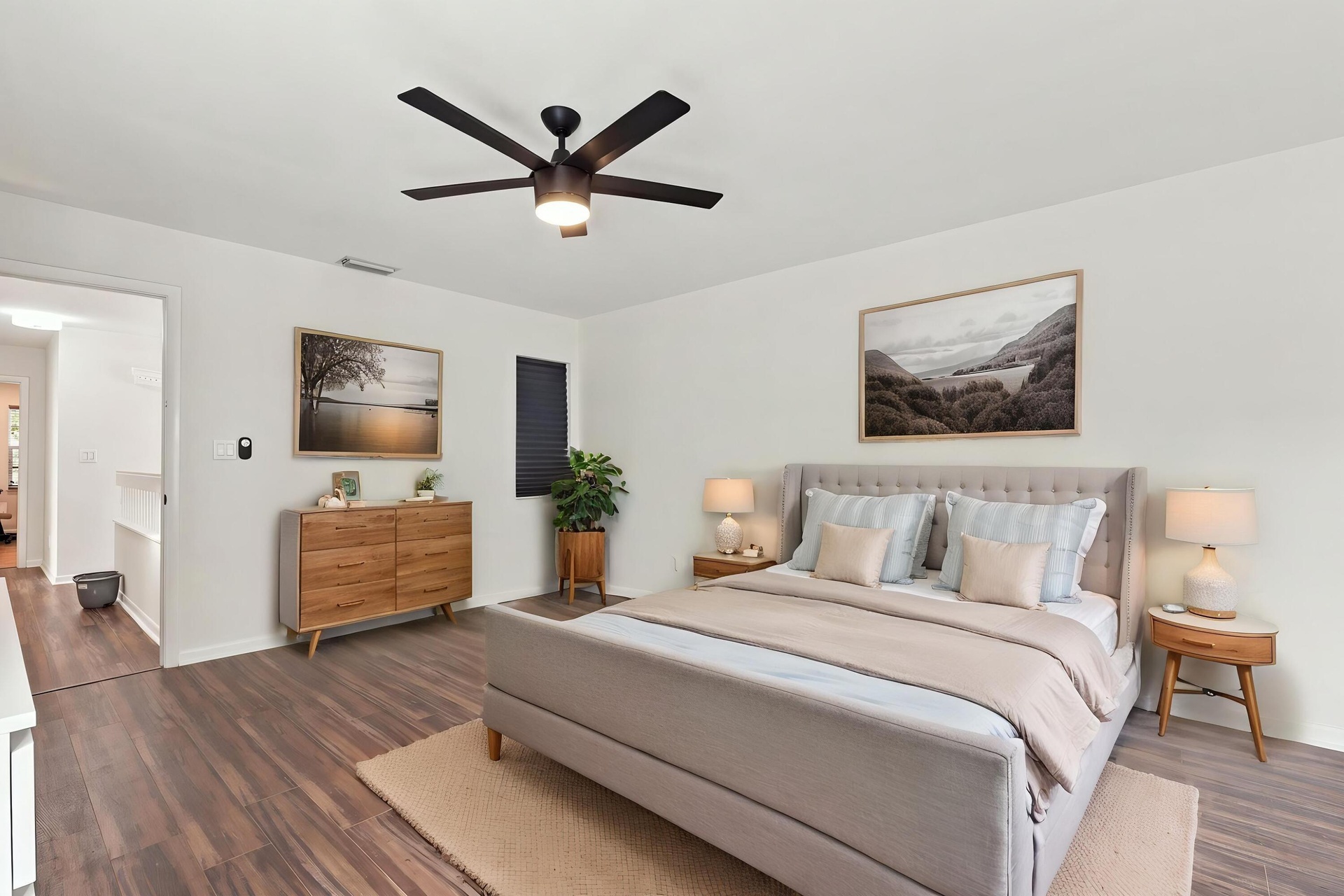 The elegant primary suite offers a private retreat with a beautifully updated bathroom, spacious walk-in closets, and a private balcony overlooking th