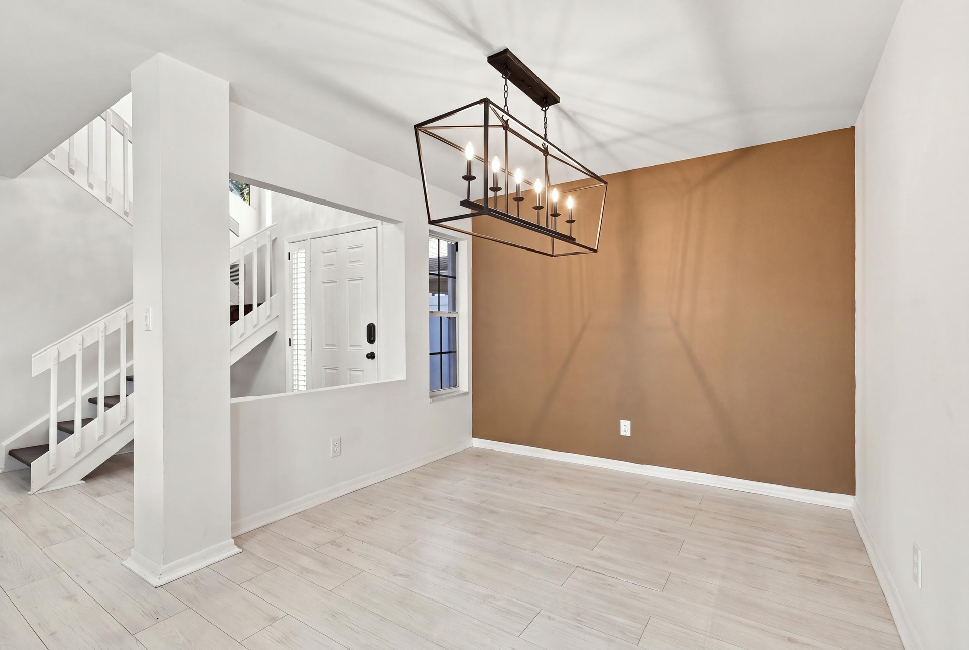 The open-concept floor plan seamlessly connects the living room and elegant formal dining area, creating an inviting setting for memorable dinners and