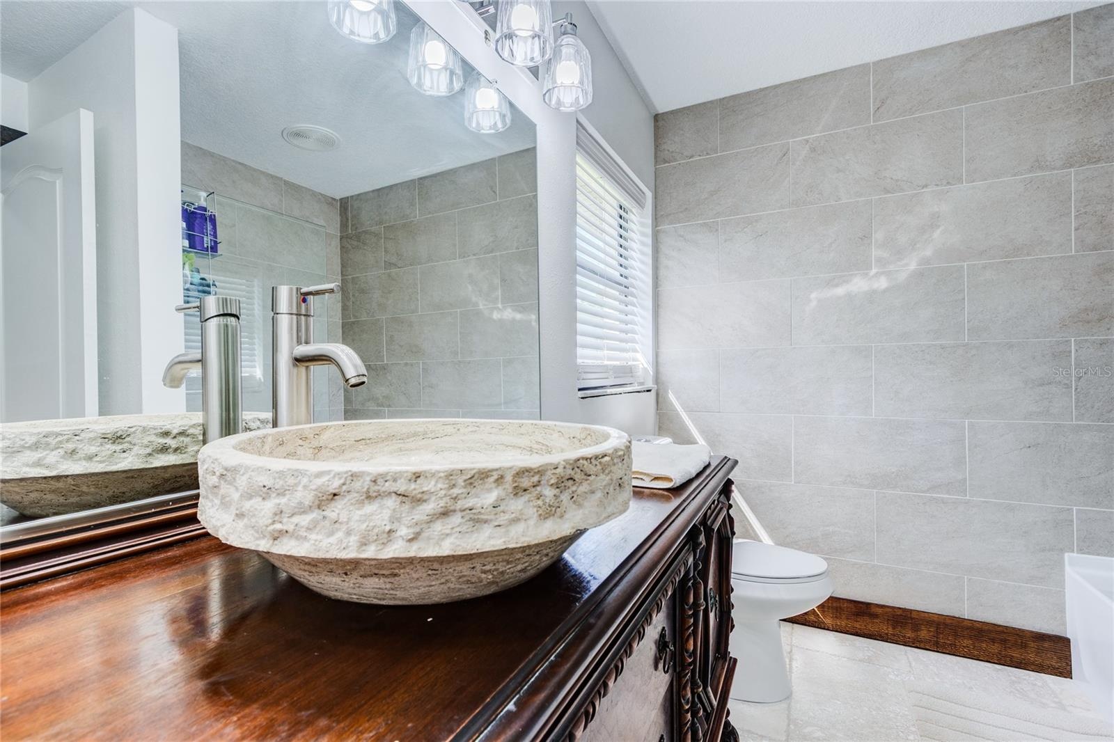 Travertine sink and antique wood vanity!