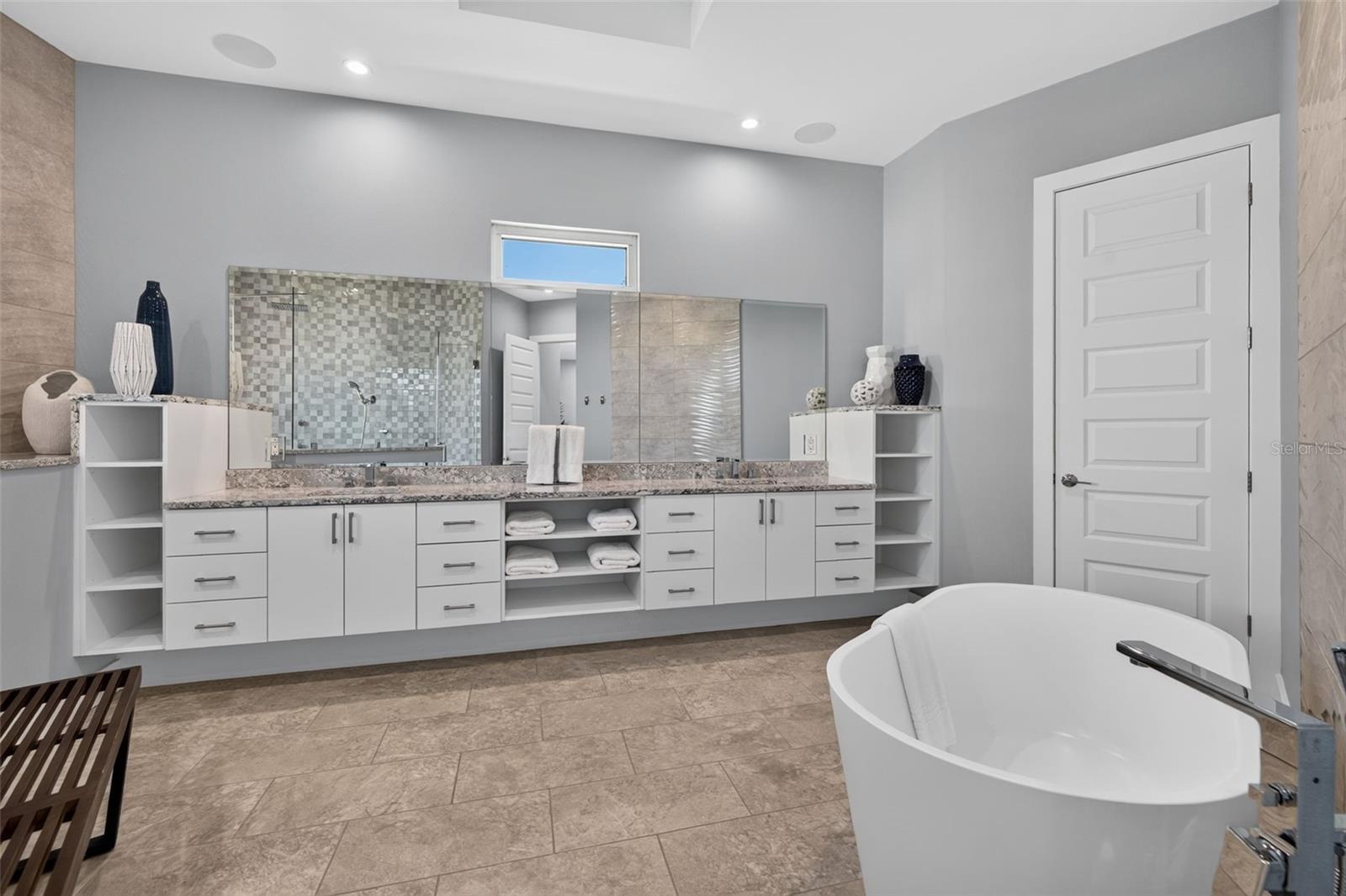 Soaking tub with double vanity and walk-in shower.