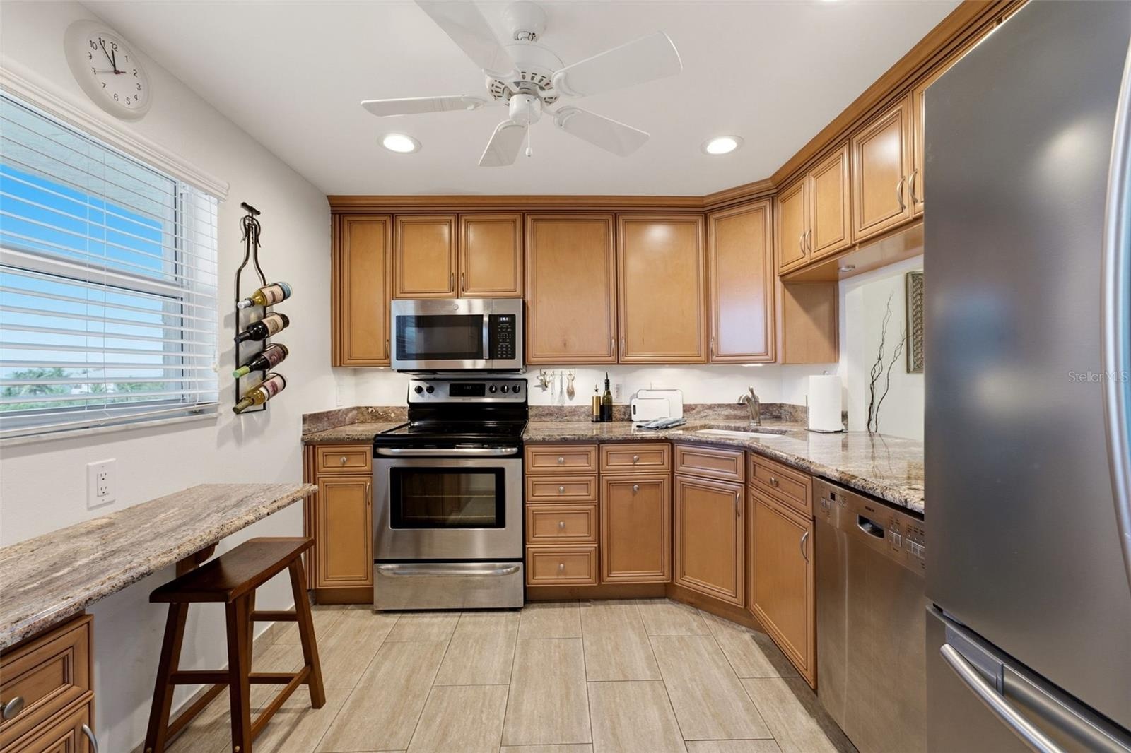 Well-appointed kitchen with solid-wood cabinetry and granite countertops.